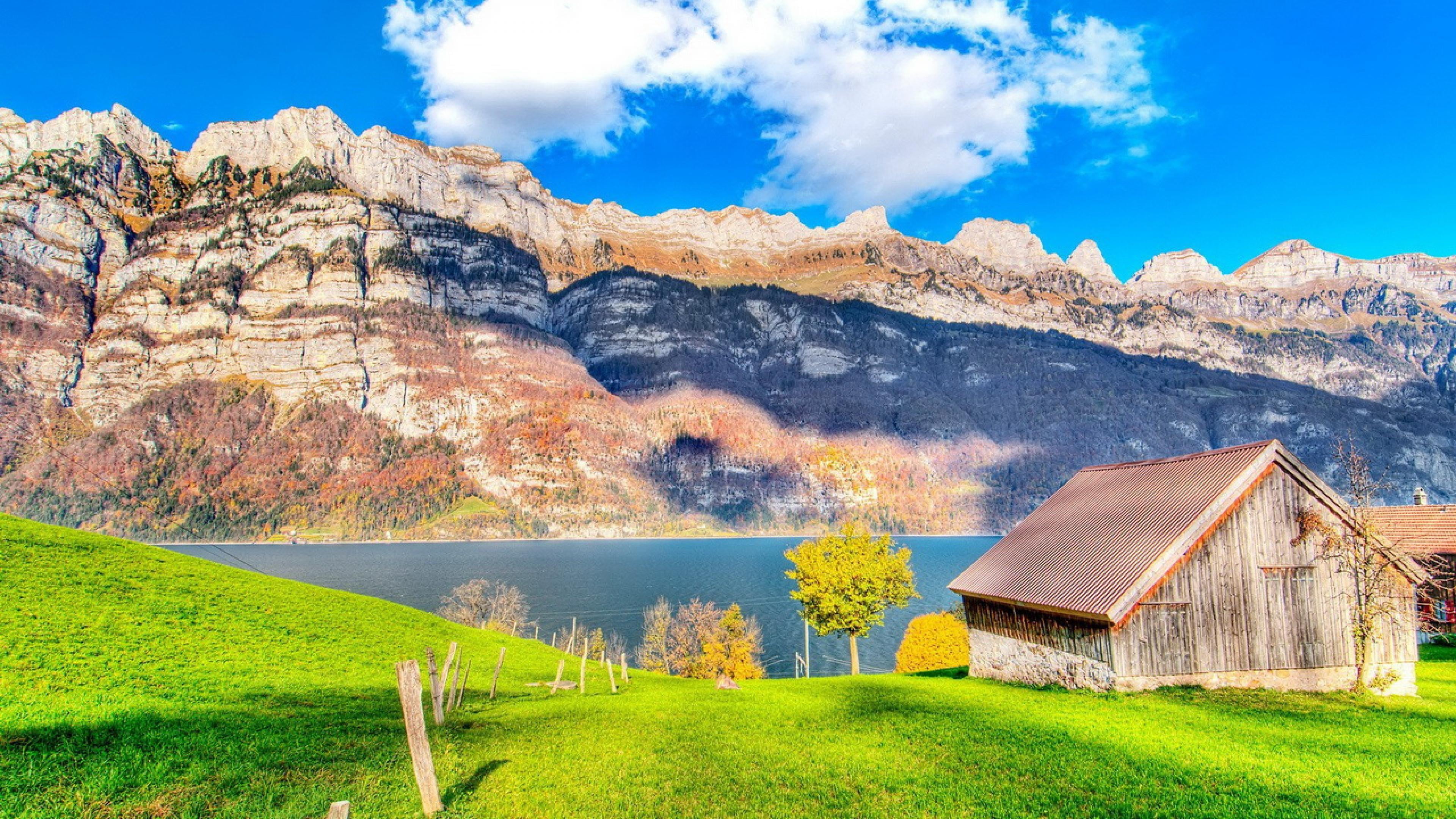 non-urban scene, rocky, mountain, green color, grass, blue sky, formation, view, building, mountains, tree, lake, hut, cabin, house, scenics - nature, 4K, HD Wallpaper