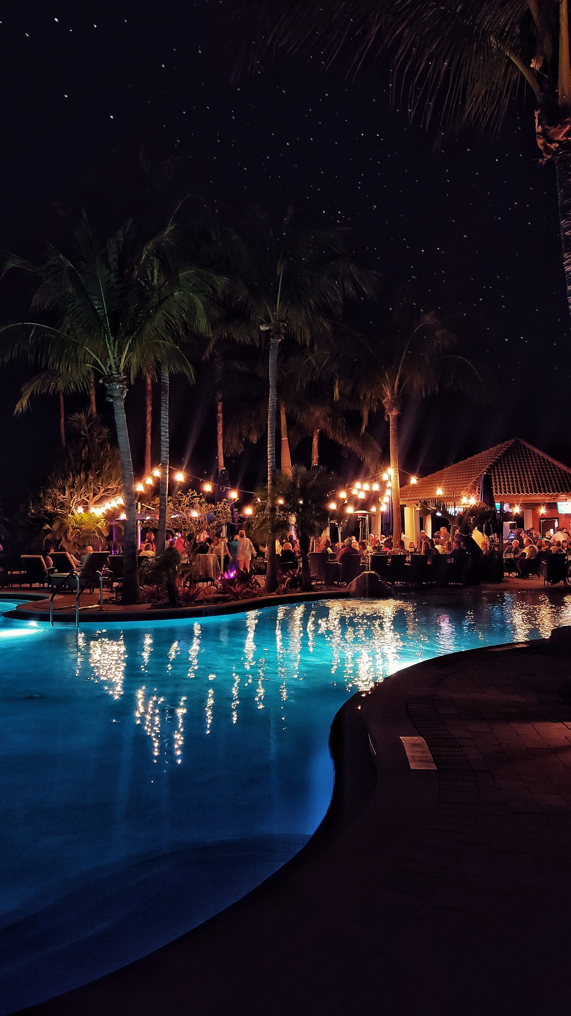 resort, outdoors, standing, city, architecture, lighting equipment, 4K, illuminated, glowing, town, sea, pool, tree, sky, summer, club, night, no people, Phone HD Wallpaper