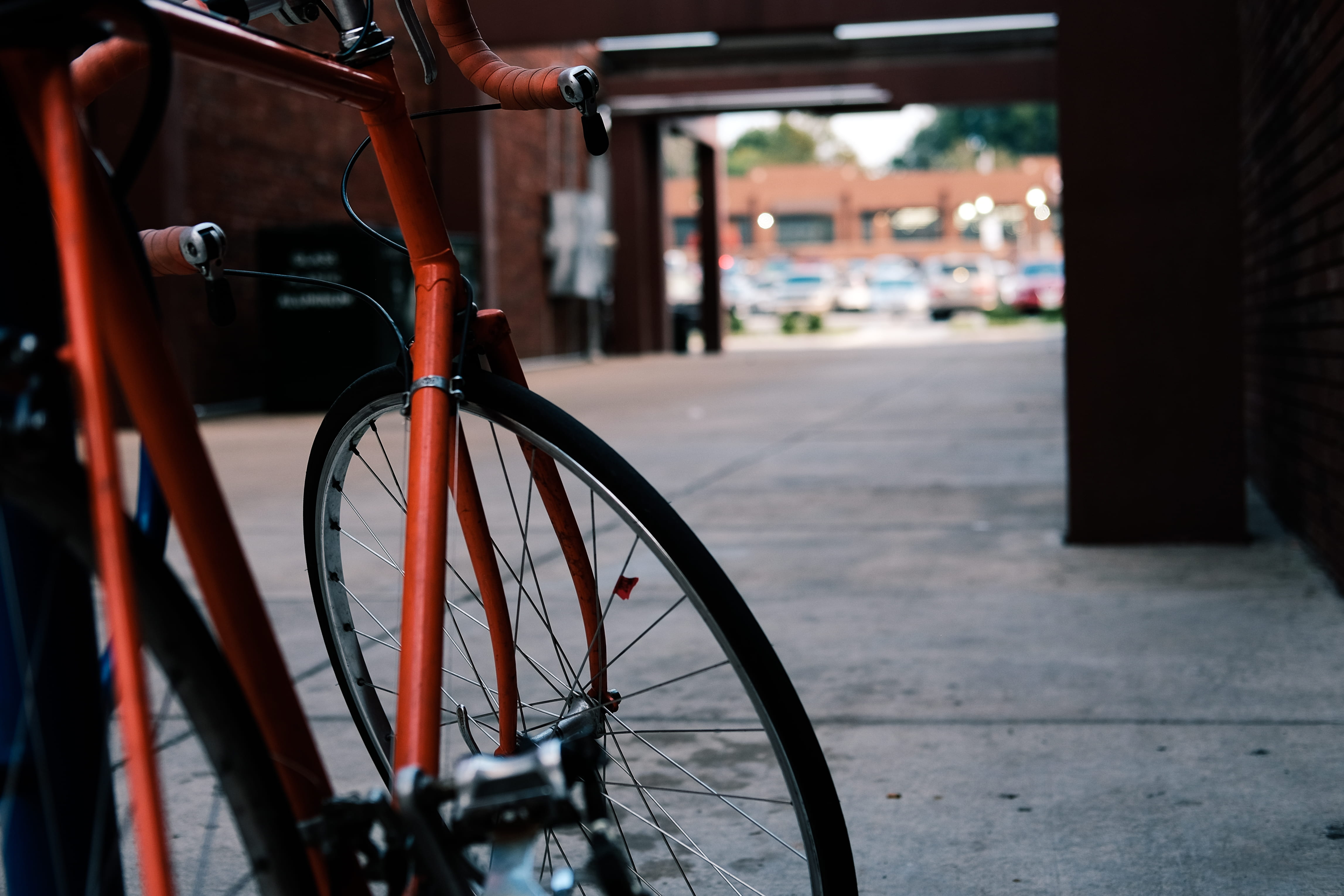 red, built structure, sidewalk, wheel, wall, mode of transportation, black, day, gray, architecture, outdoors, road, stationary, beside, tire, footpath, HD Wallpaper