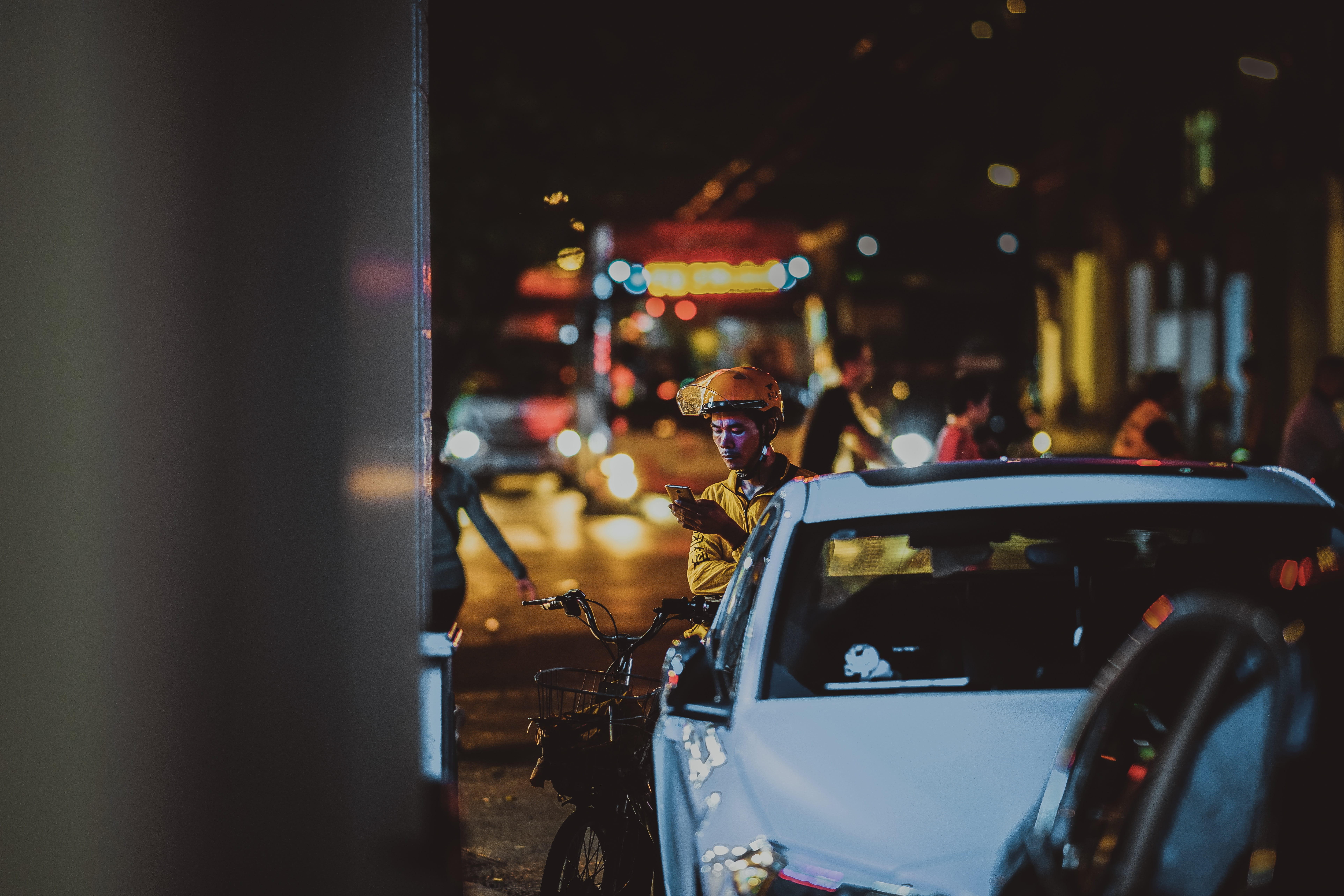 vehicle, illuminated, near, lifestyles, yellow, man, person, apparel, men, helmet, street, outdoors, people, motor vehicle, photography, selective focus, HD Wallpaper