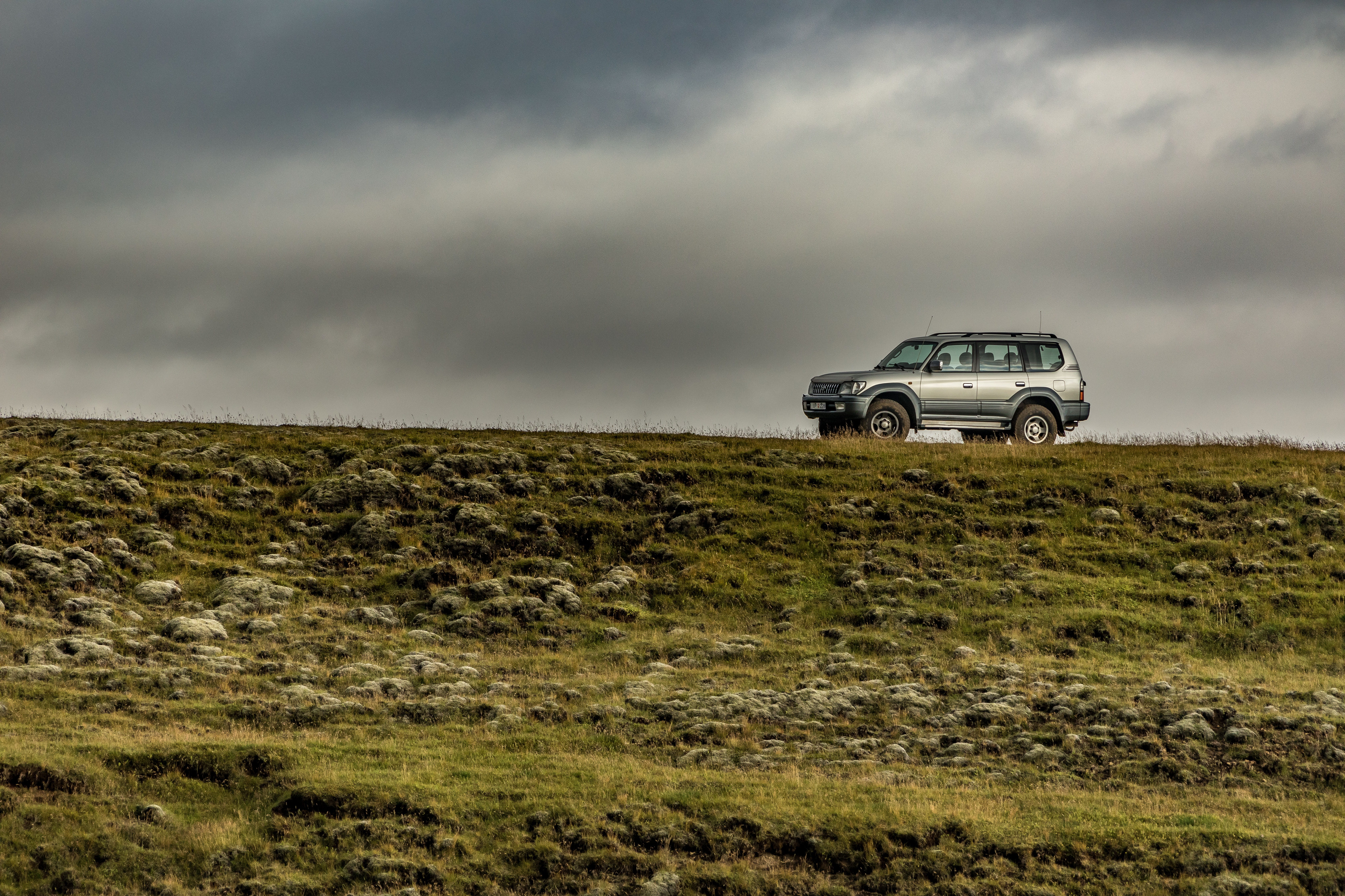 offroad, storm, no people, clouds, 5K, jeep, meadow, grass, sky, land, environment, road trip, fields, parking, water, field, overcast, motor vehicle, HD Wallpaper