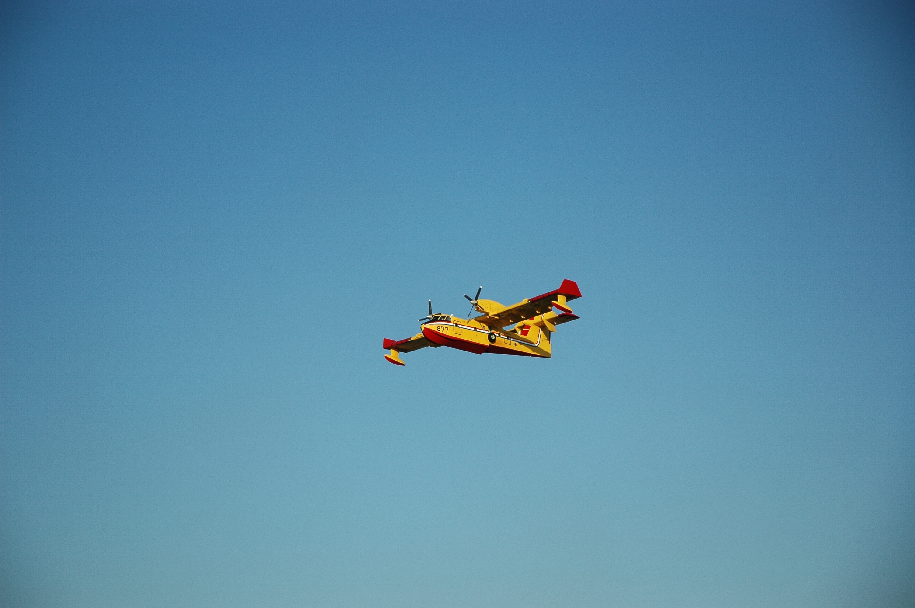 seaplane, clear sky, yellow, airplane, motion, day, flying, outdoors, mid-air, plane, sky, blue, airshow, mode of transportation, nature, on the move, no people, HD Wallpaper