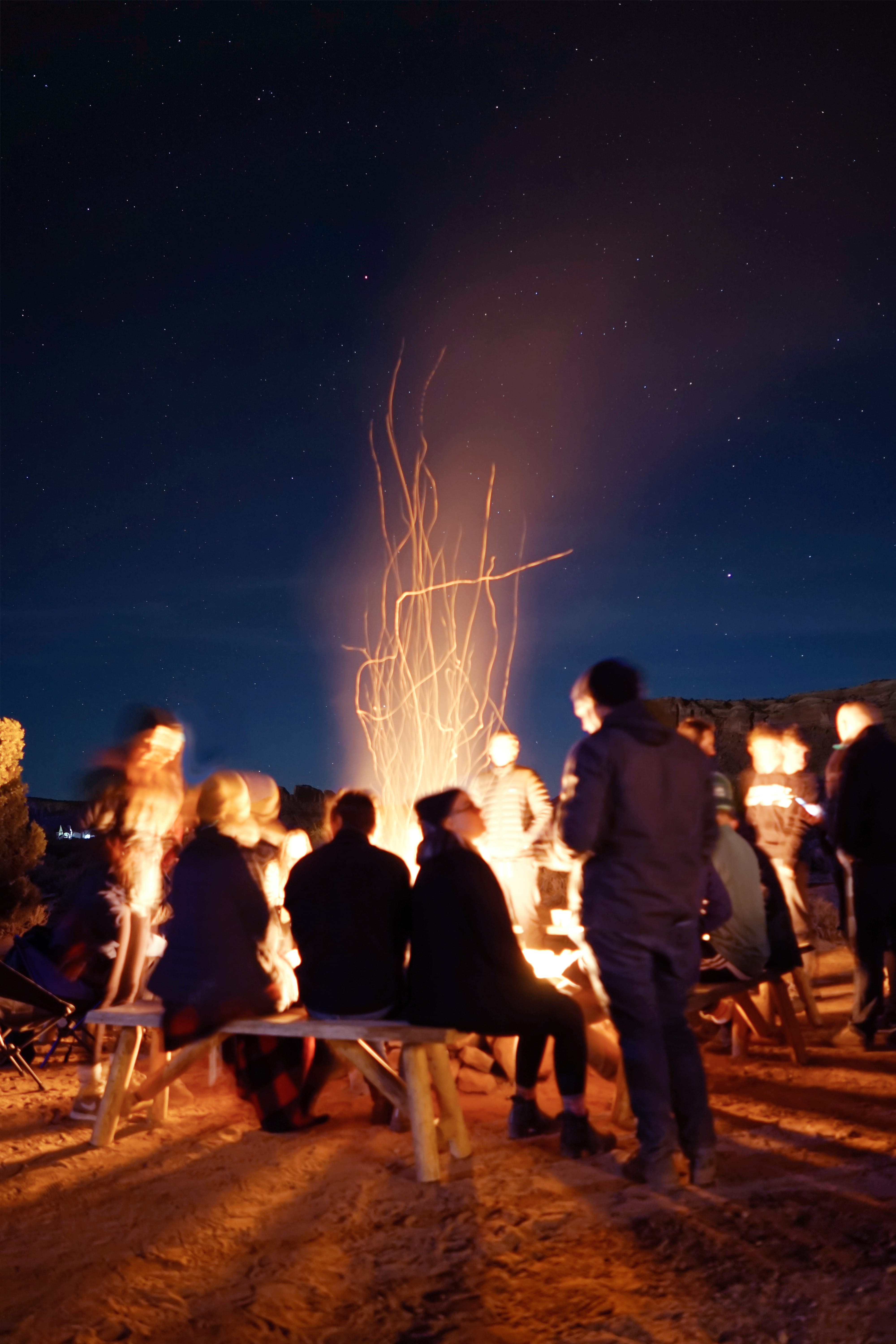 adult, fire, motion, outdoors, bonfire, star, crowd, night, standing, real people, fire - natural phenomenon, long exposure, burning, flame, nature, group of people, Phone HD Wallpaper