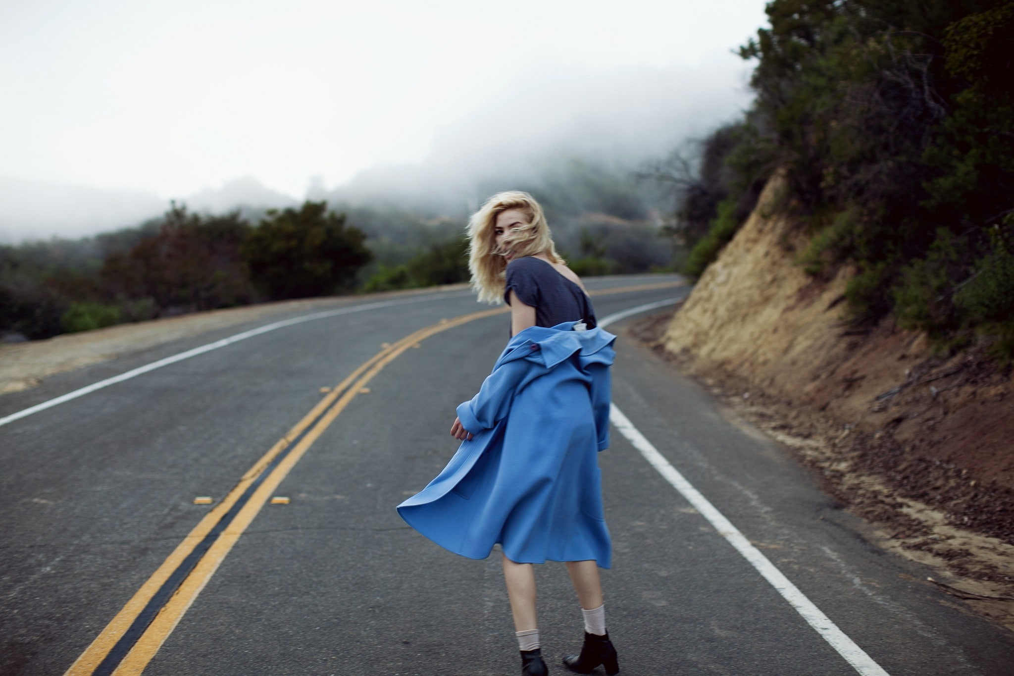 road, looking back, looking over shoulder, 1080P, hair in face, blonde, blue coat, women outdoors, windy, women, model, HD Wallpaper