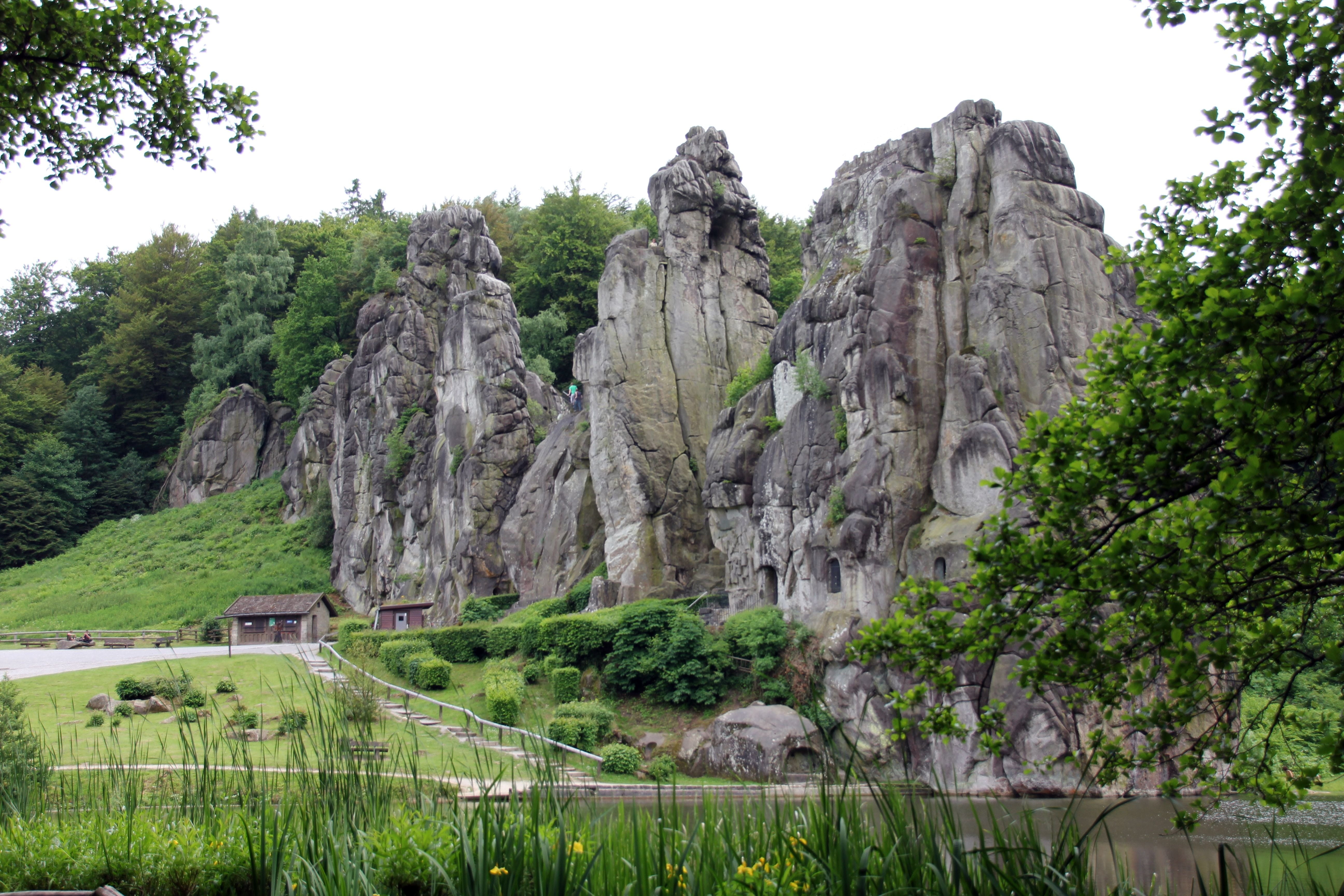 teutoburg forest, grey, land, stones, formation, mountain, externsteine, green color, no people, clear sky, solid, rock, water, day, beauty in nature, tranquil scene, HD Wallpaper