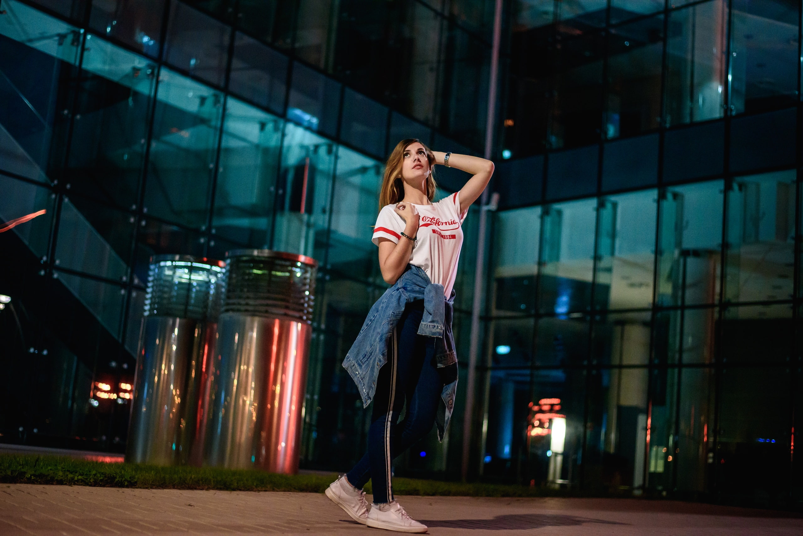 arms raised, office building exterior, glass, depth of field, women outdoors, jeans, 2K, front view, model, built structure, women, architecture, jeans jacket, HD Wallpaper