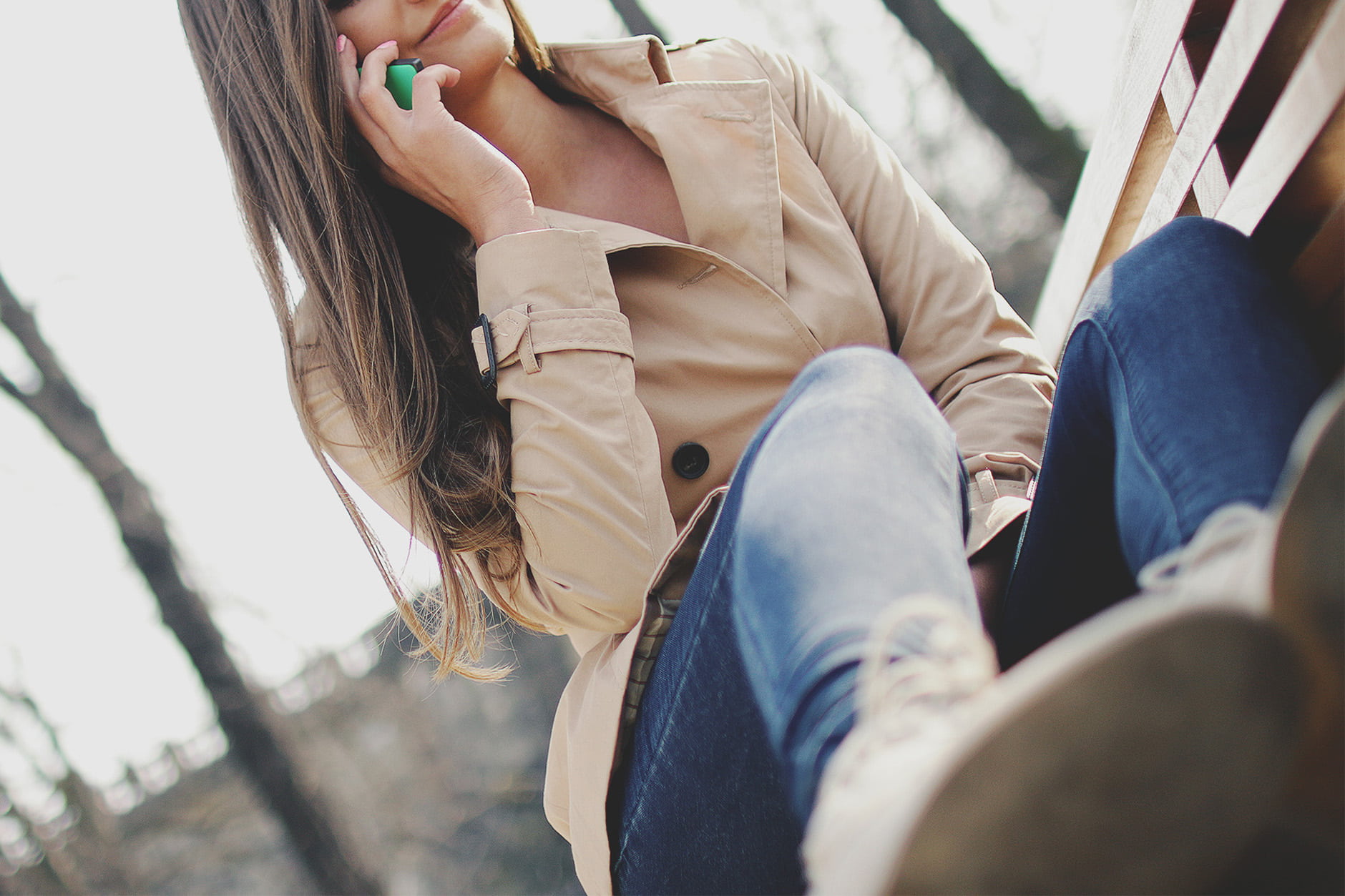 enjoyment, leisure activity, holding, portrait, calling, people, real people, young women, adult, jeans, technology, bench, nature, coat, city, long hair, HD Wallpaper