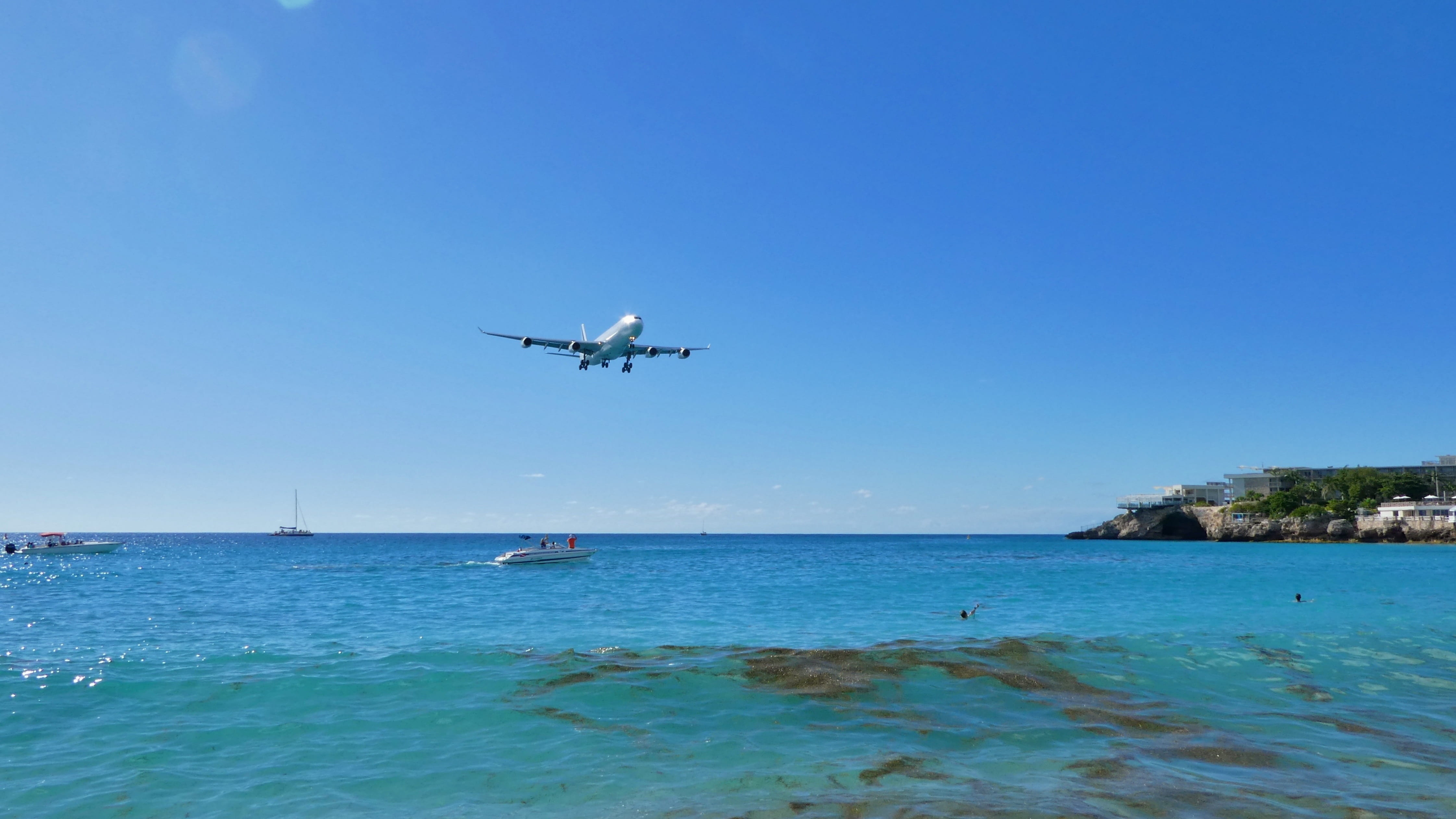 mid-air, motion, air vehicle, 4K, nature, no people, blue, travel, land, water, clear sky, sky, outdoors, mode of transportation, maho beach, scenics - nature, HD Wallpaper