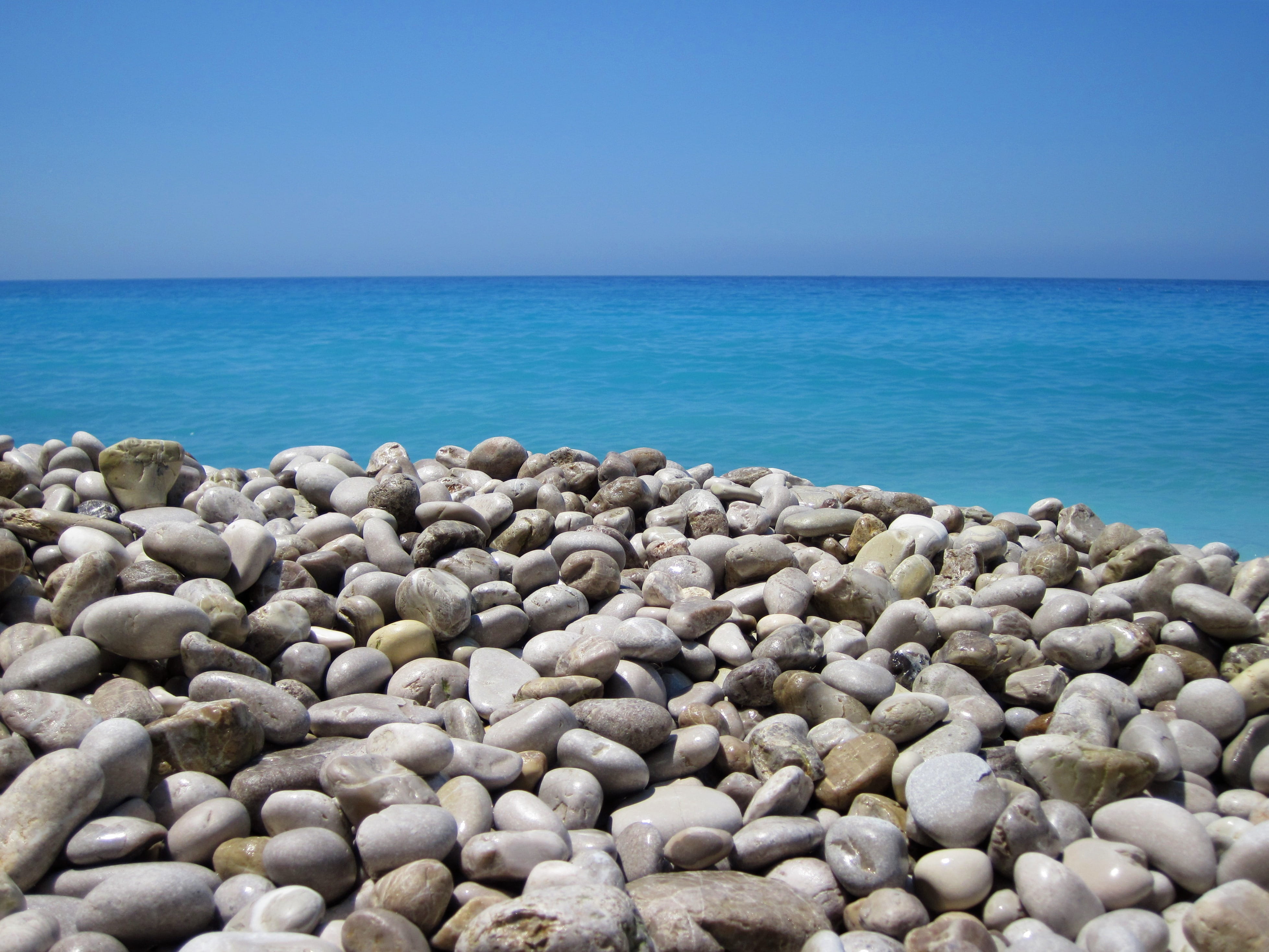 daytime, round, 4K, beach, stones, water, land, no people, tranquil scene, abstract, wet, rock - object, pebble, rock, horizon, wide, sea, day, solid, HD Wallpaper