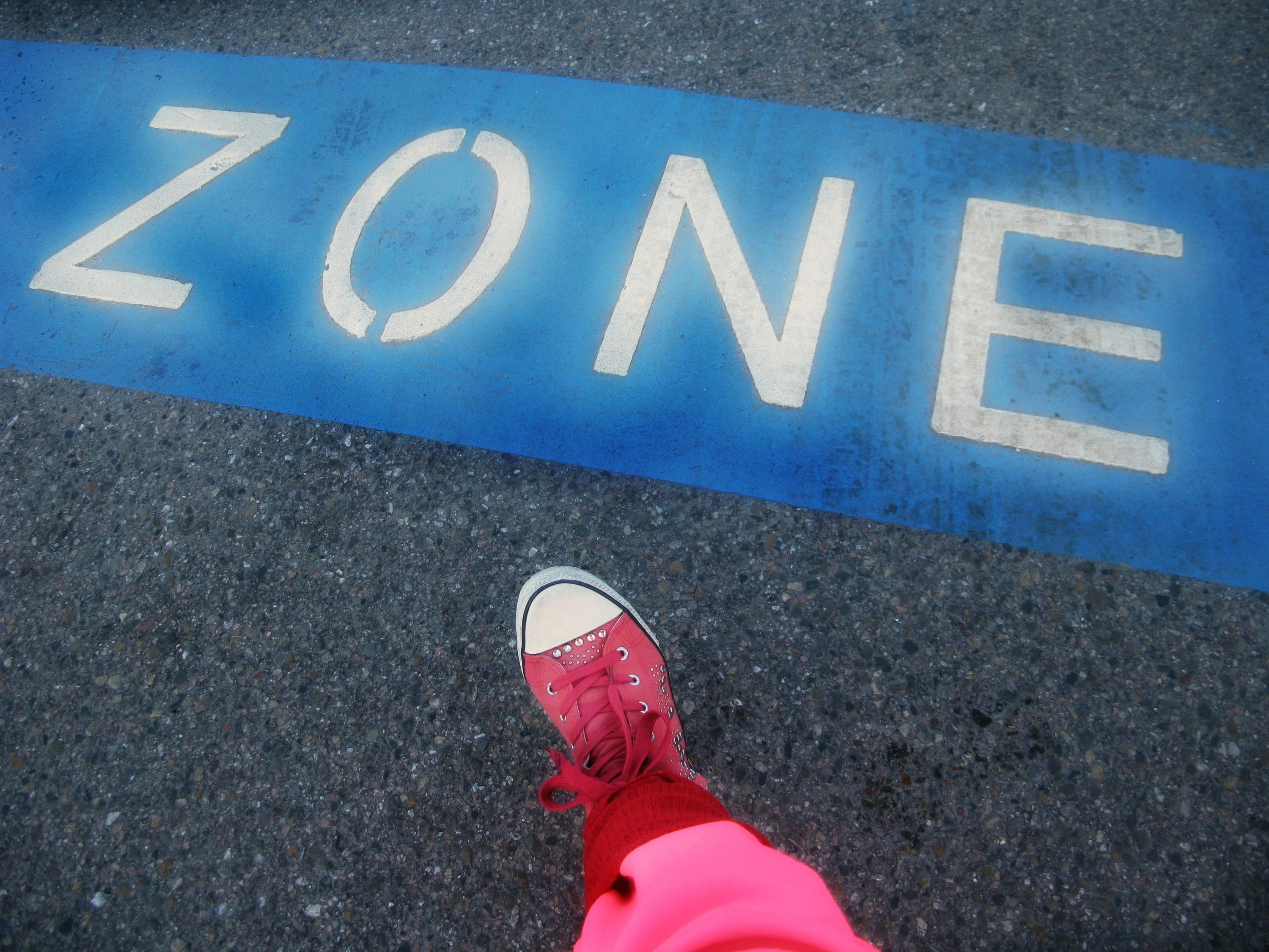 symbol, high angle view, shoe, human limb, pink, body part, europa boulevard, city, one person, text, foot, real people, personal perspective, road, outdoors, HD Wallpaper