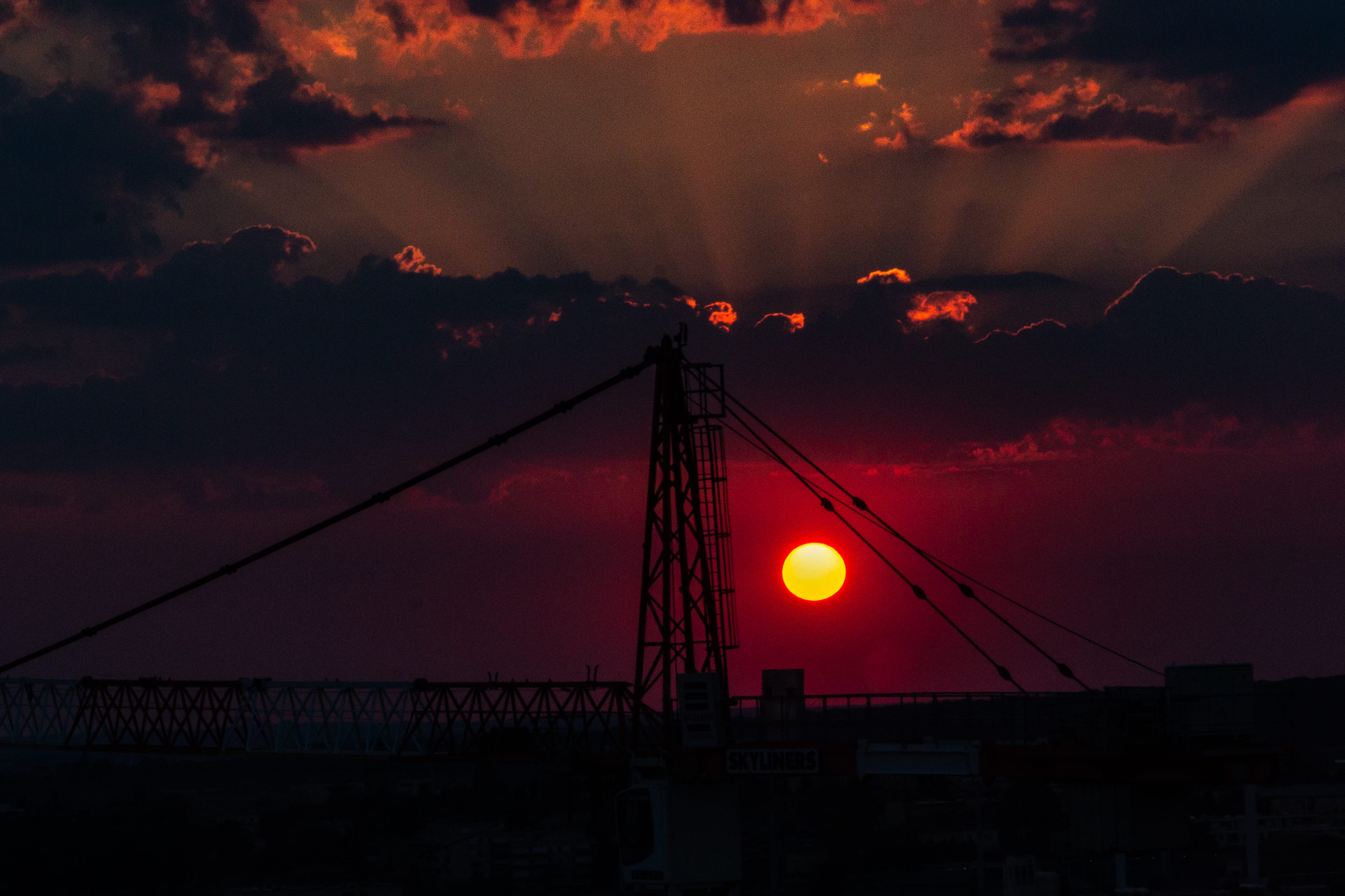 outdoors, dramatic sky, low angle view, sun, orange color, cloud - sky, building exterior, machinery, silhouette, 2 boulevard franklin delano roosevelt, HD Wallpaper