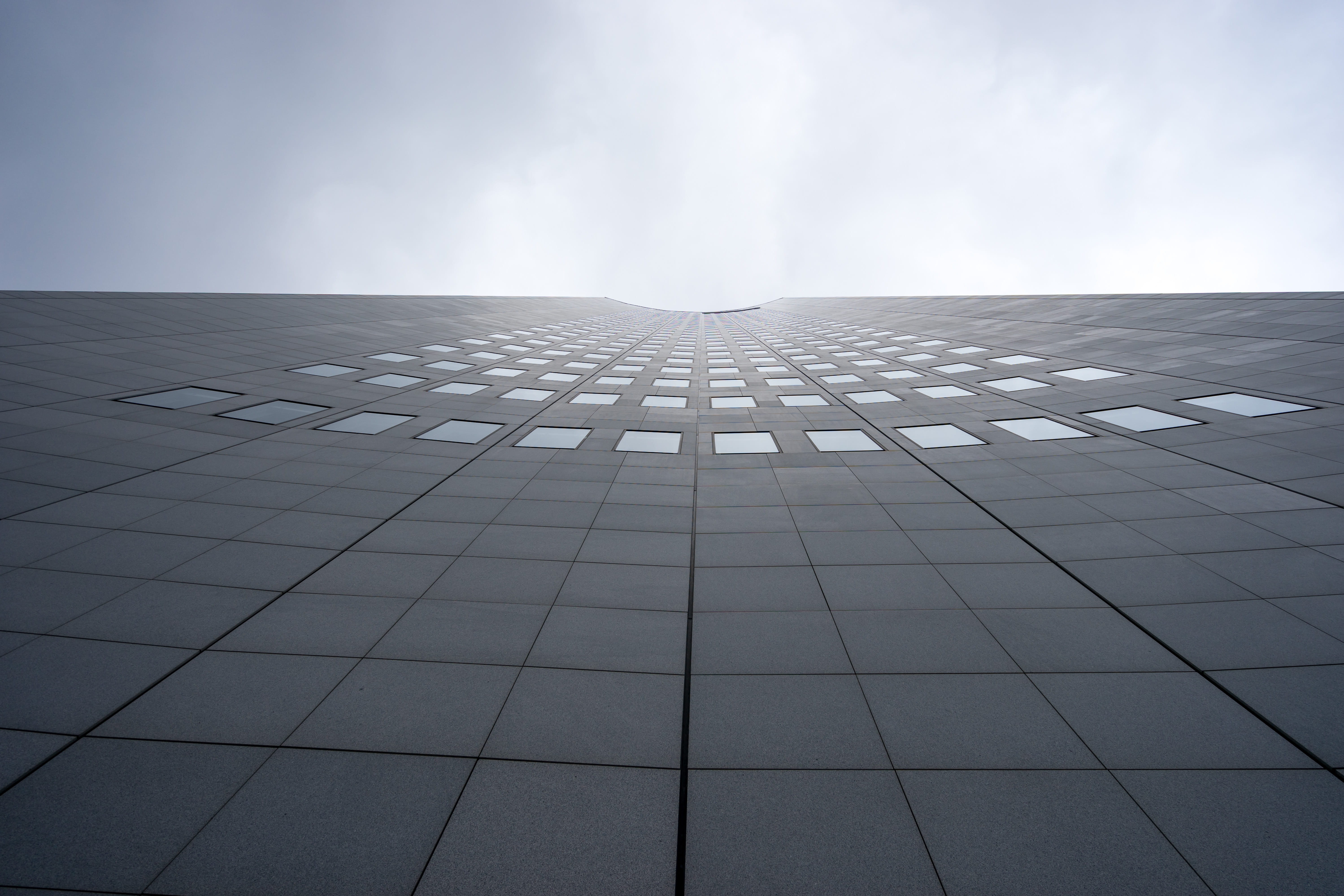 building, 5K, day, holes, no people, skyscraper, lines, cloud - sky, directly below, curved, converging, small, outdoors, nature, windows, overcast, city, HD Wallpaper