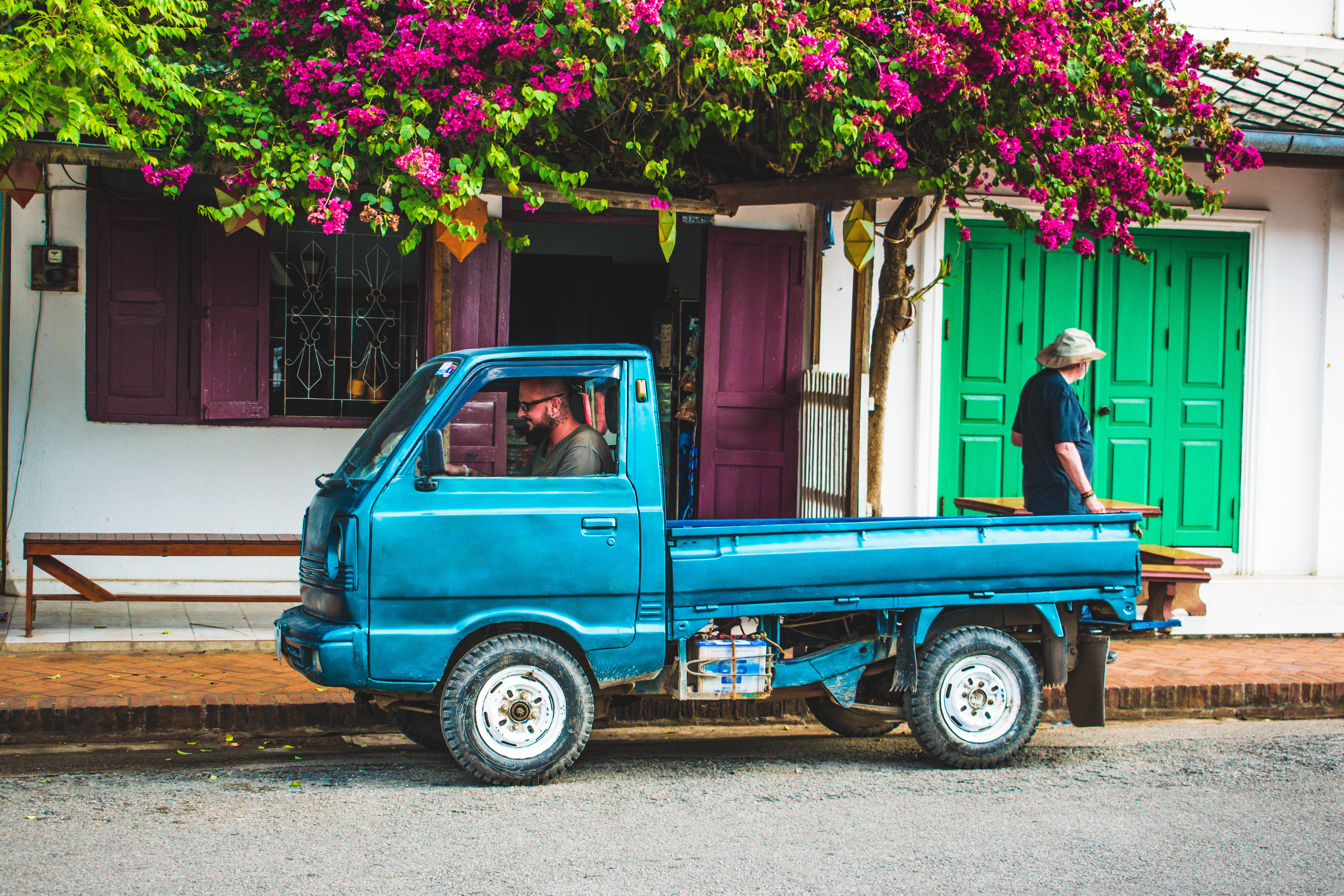 city, flower, two people, side, day, driving, blue, mini, mode of transportation, building exterior, built structure, land vehicle, plant, men, people, HD Wallpaper