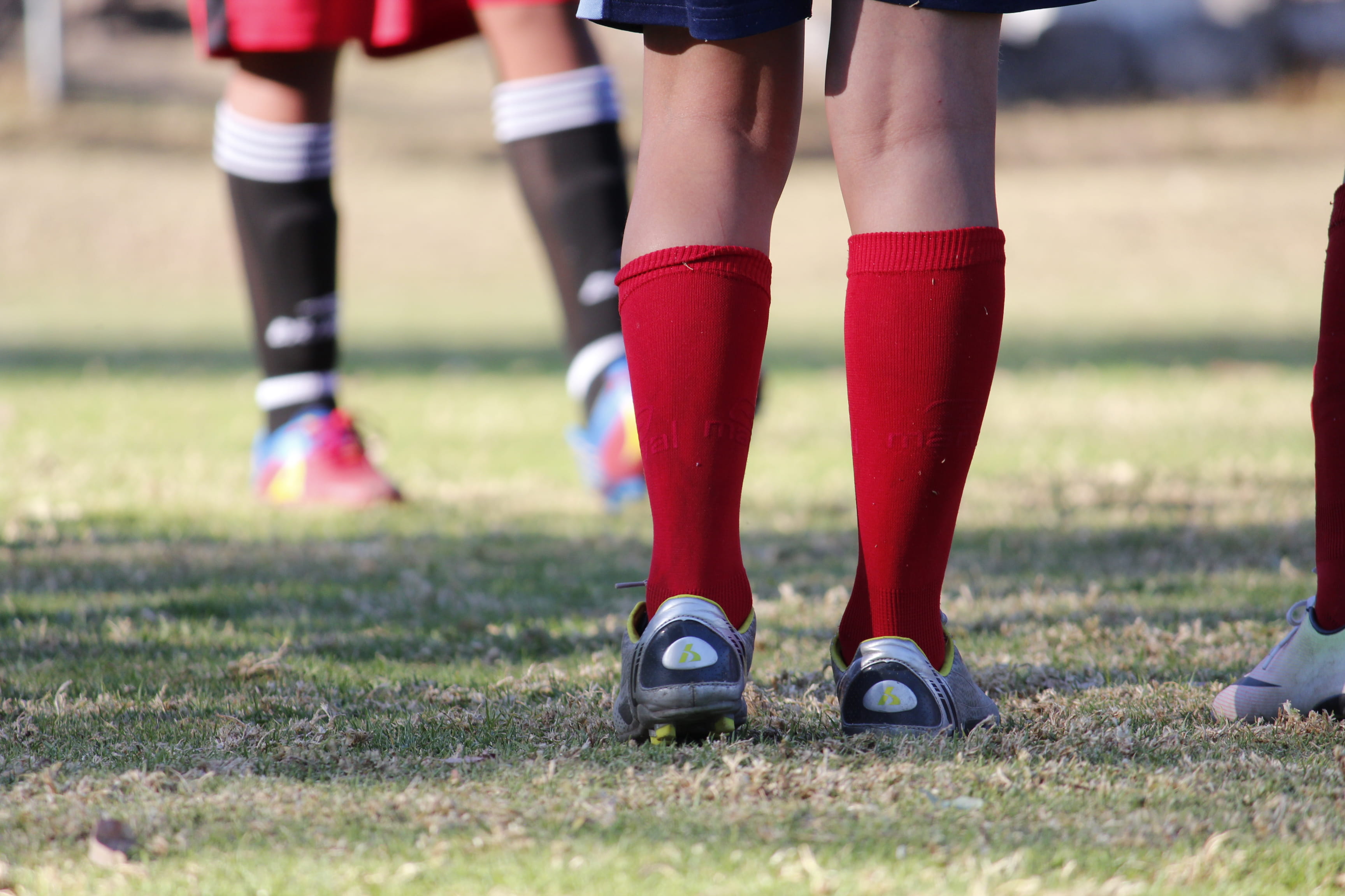low section, body part, togetherness, sport, limb, human body part, outdoors, child, shoe, standing, sports, socks, human leg, red, surface level, 2K, HD Wallpaper