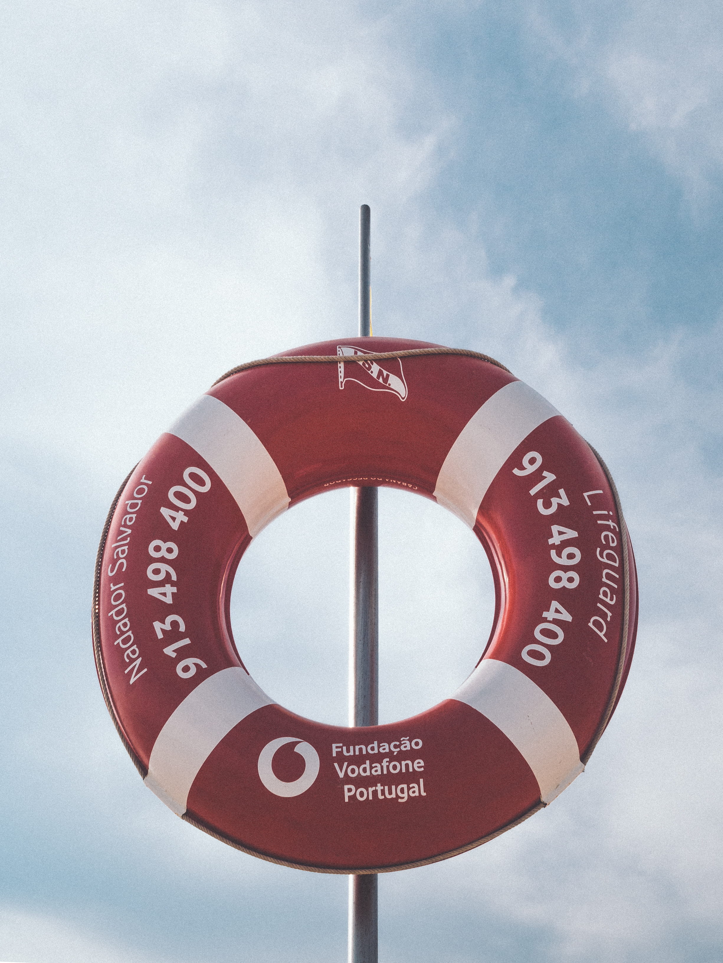 circle, vodafone, safety, photo, number, no people, red, text, inflatable, sign, day, pole, shape, white, information, low angle view, 2K, outdoors, sky, Phone HD Wallpaper