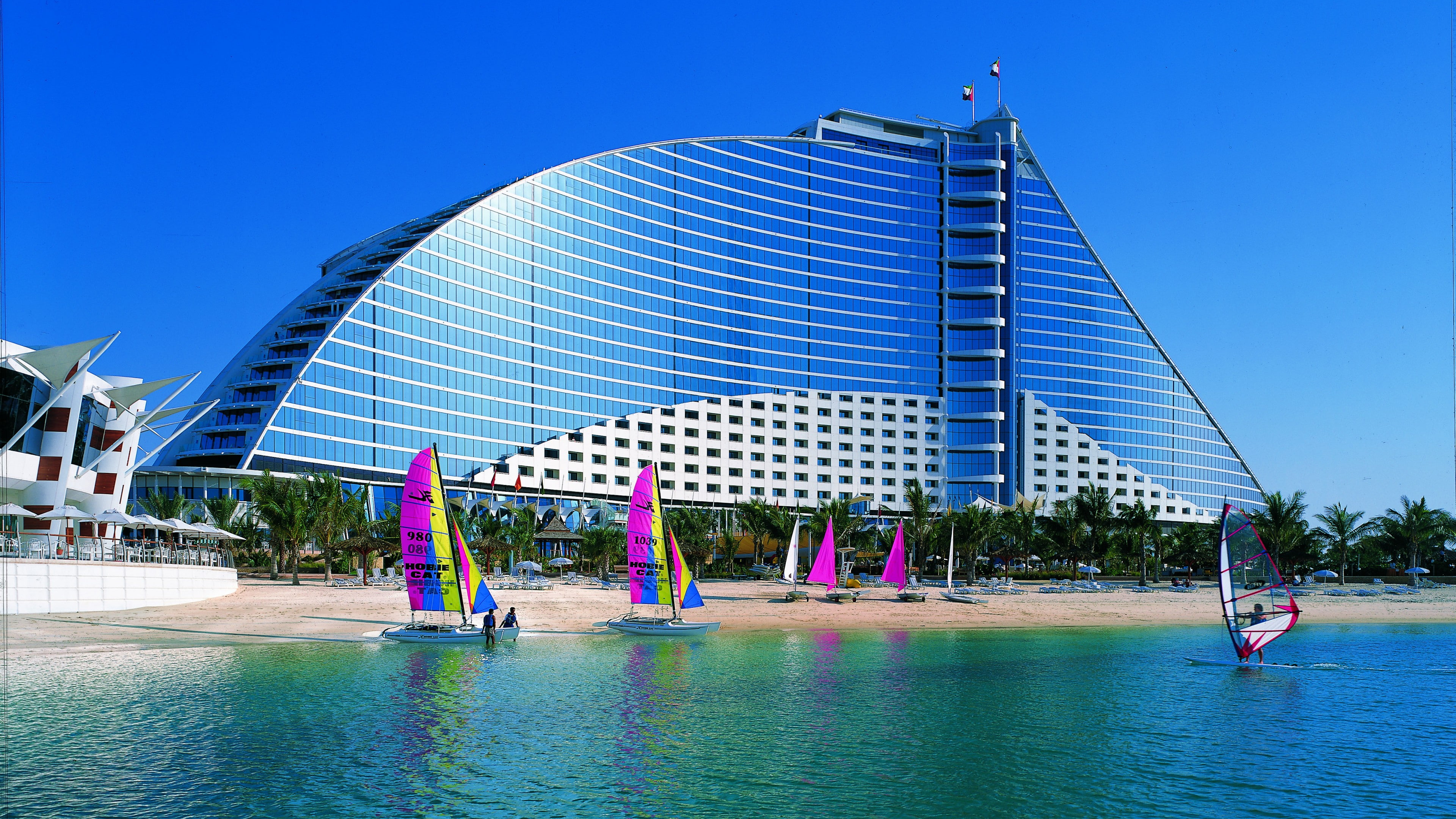 sand, boat, beach, 4K, two, green, Hotel, sea, water, Jumeirah Beach, ocean, resort, daytime, seashore, pink, sailing, blue, travel, booking, Dubai, sunny day, HD Wallpaper