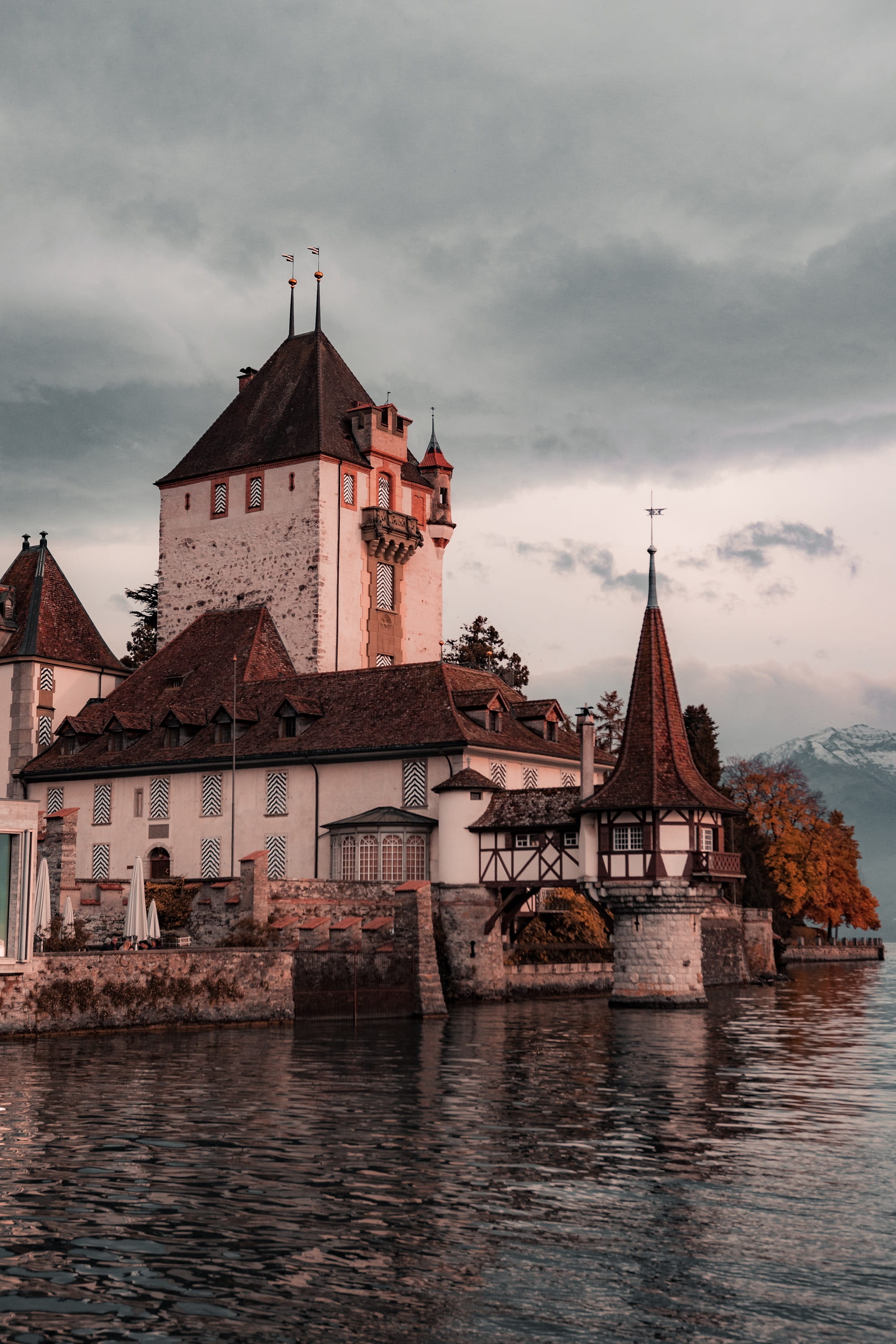 architecture, lake, castle, building exterior, 2K, overcast, painted, place of worship, fort, spire, water, nature, oberhofen, built structure, white, Phone HD Wallpaper