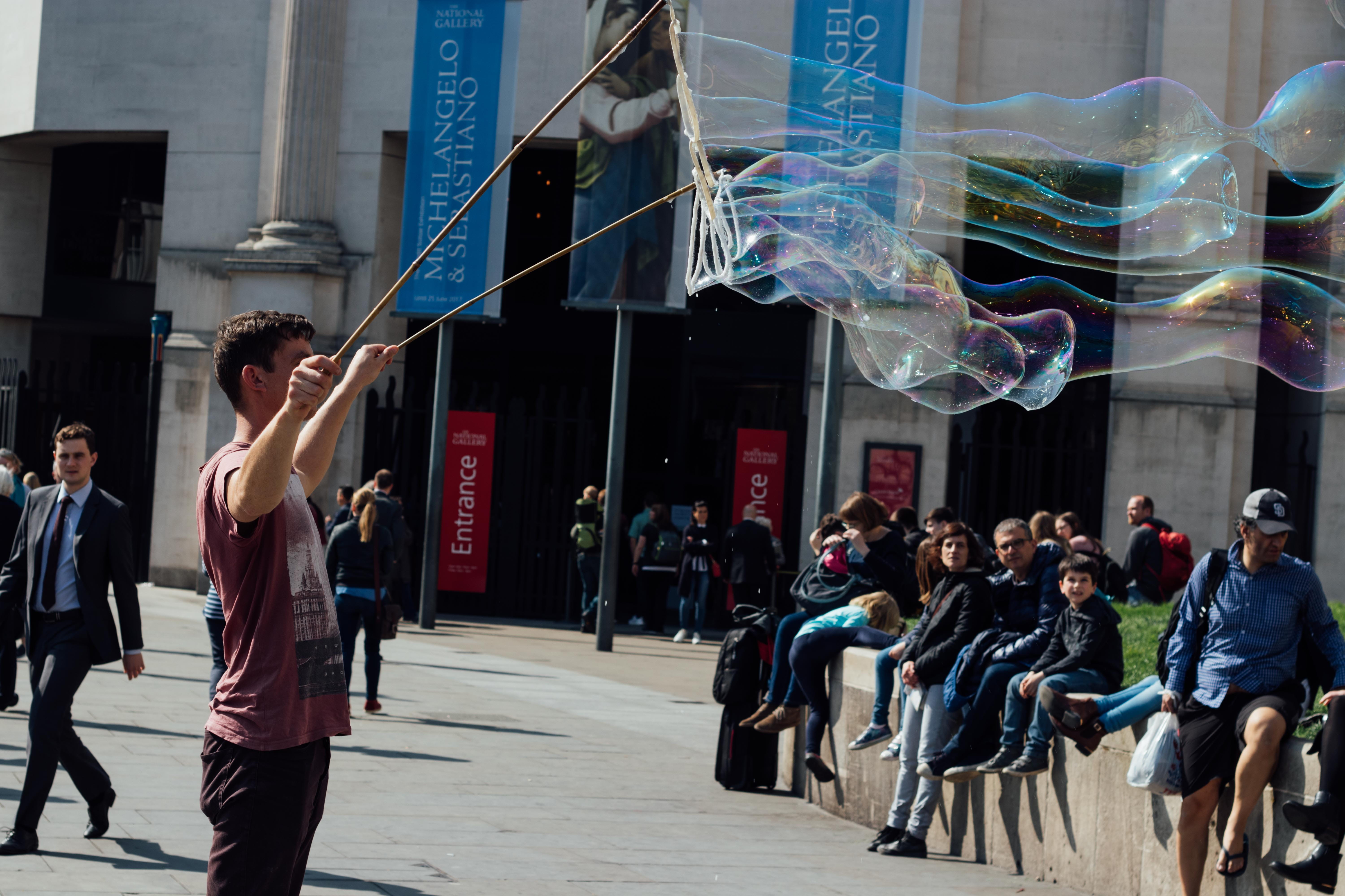 bubbles, group of people, men, london, united kingdom, street, city life, motion, trafalgar square, adult, women, street performer, real people, building exterior, HD Wallpaper