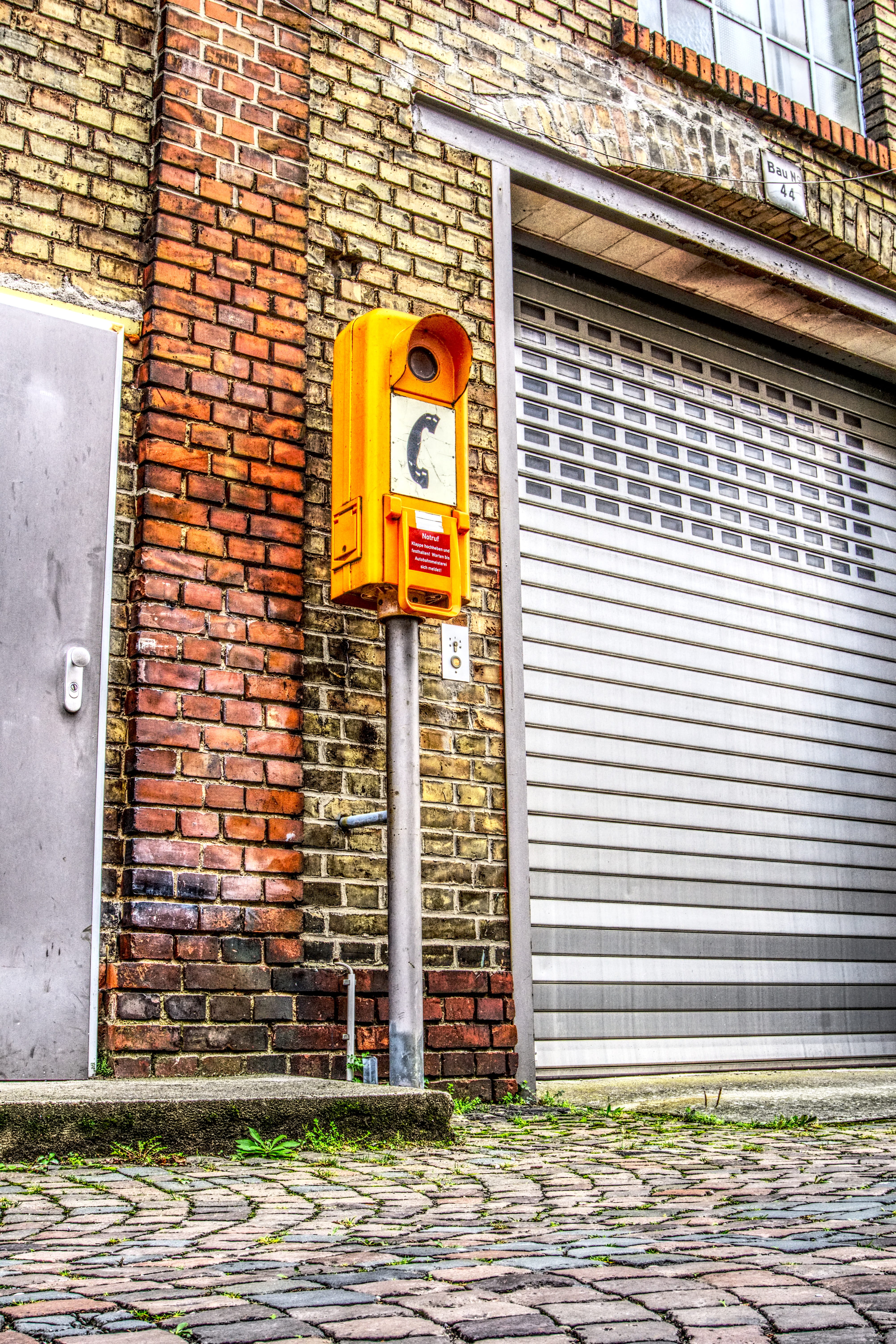 road sign, building, safety, industrial building, emergency telephone, built structure, brick wall, high dynamic range, yellow, communication, day, street, Phone HD Wallpaper