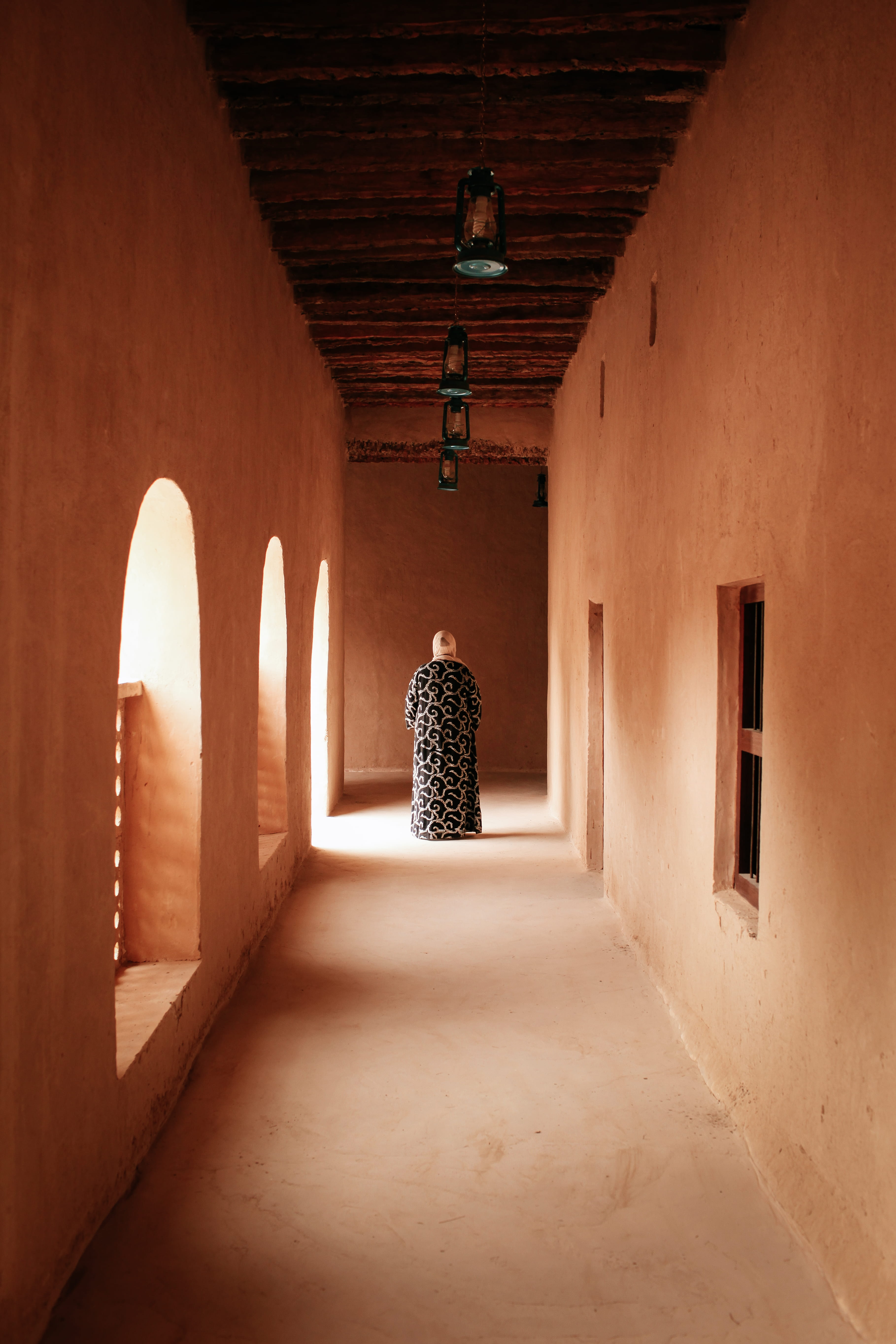 entrance, direction, door, woman, white, concrete, lighting equipment, adult, wearing, arch, architecture, dress, walking, religion, middle, arcade, built structure, Phone HD Wallpaper