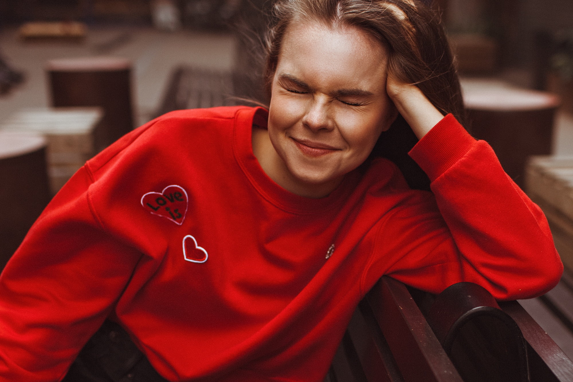 hand on head, young adult, one person, sitting, red, contemplation, bench, sweatshirts, 1080P, focus on foreground, depression - sadness, brunette, real people, HD Wallpaper