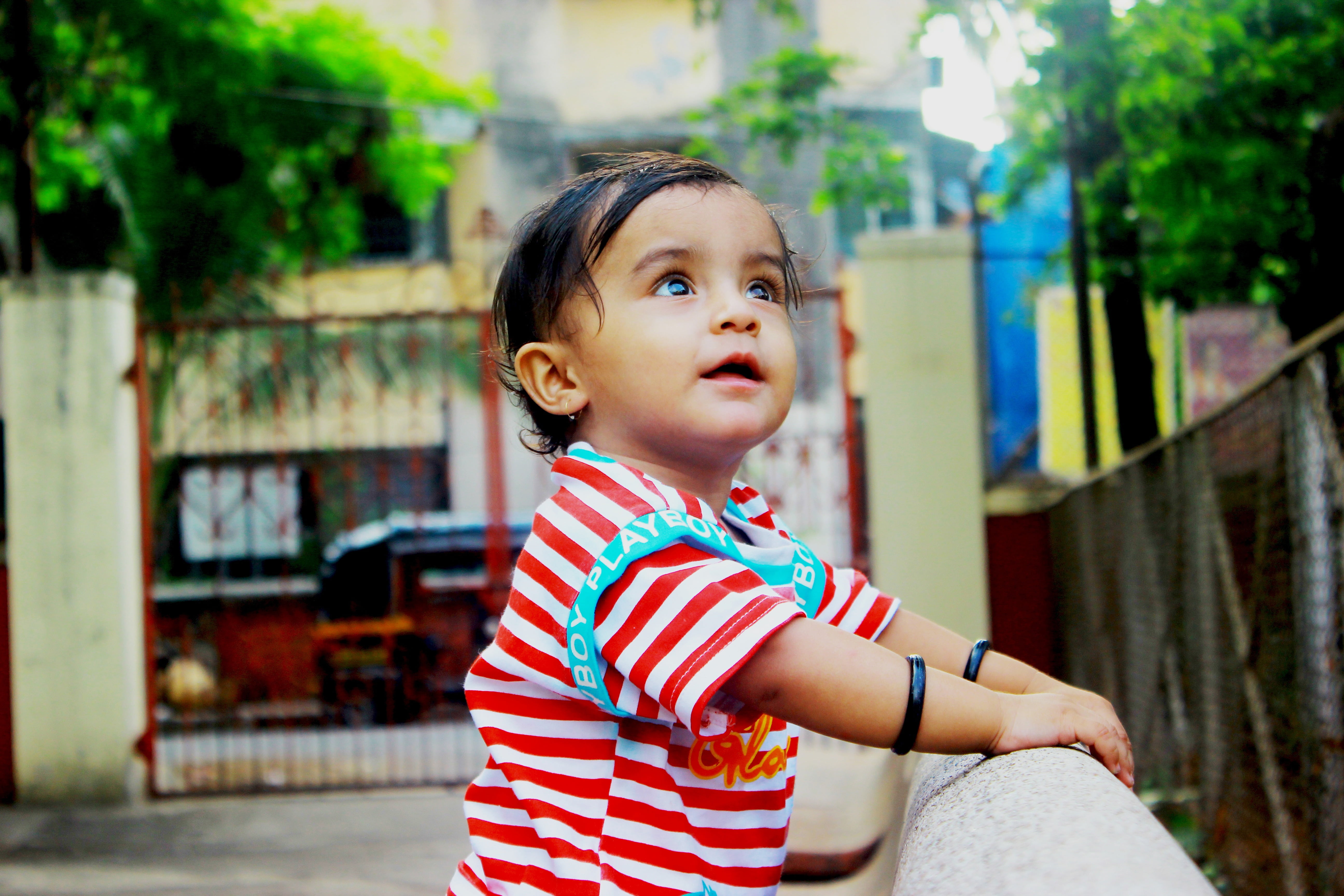 standing, infant, focus, innocence, shallow, striped, lifestyles, shirt, child, photography, looking, childhood, holding, red, indian, daytime, looking away, HD Wallpaper