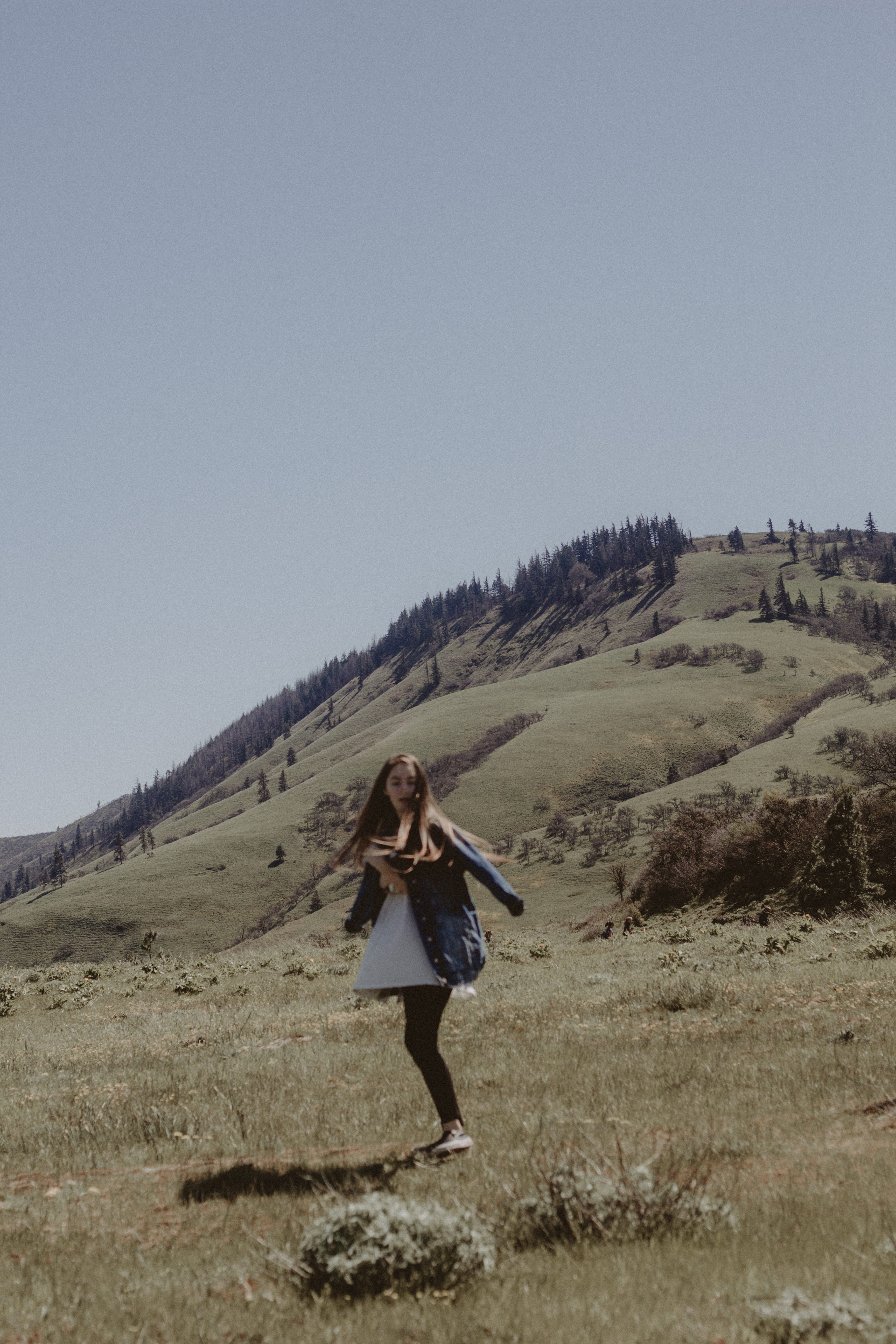 young adult, land, green, jacket, real people, hairstyle, color Image, sky, nature, one Person, green grass, one woman only, leisure activity, plant, full length, Phone HD Wallpaper