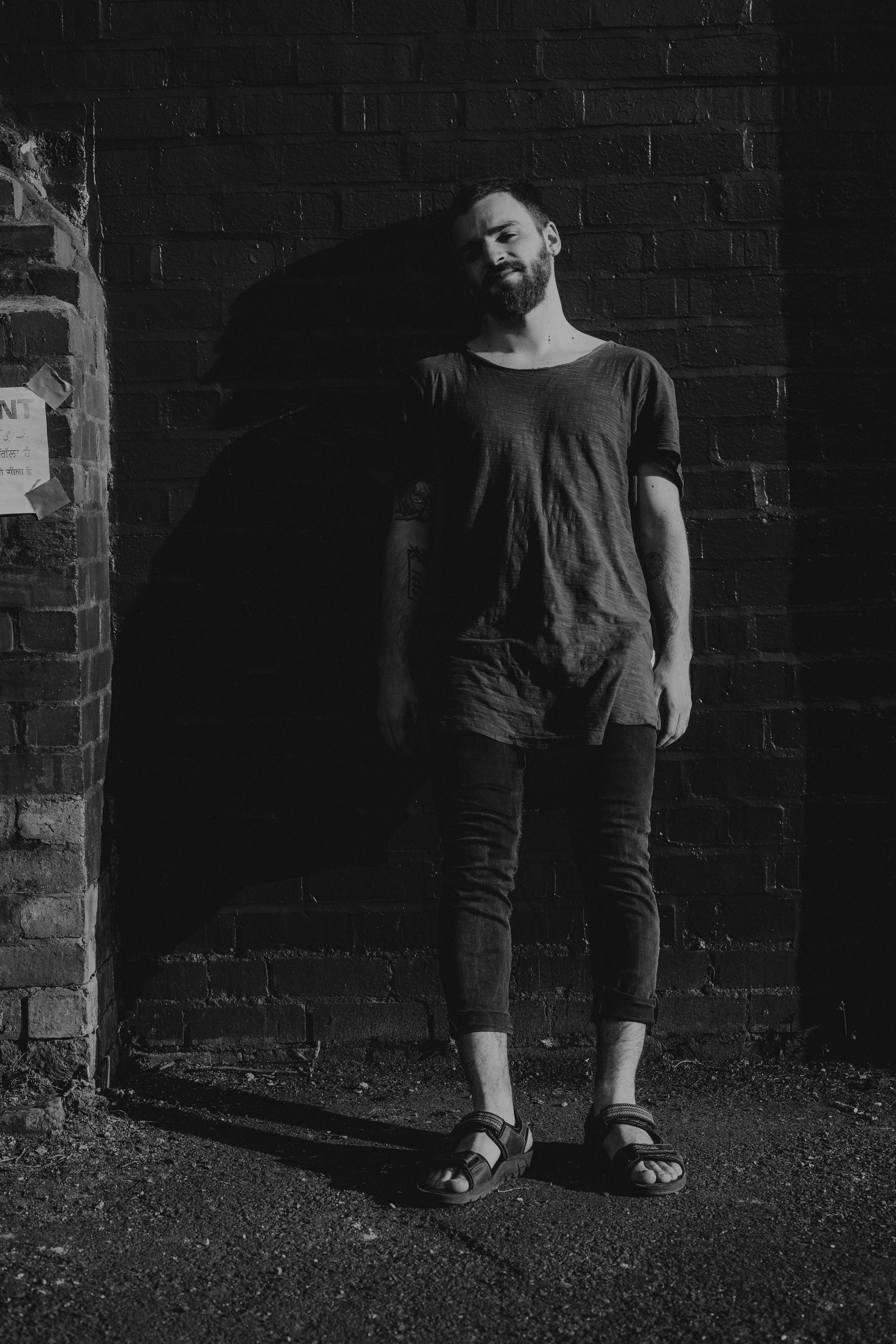 photography, brick wall, teenager, one person, young adult, beard, man, portrait, sleeve, grayscale, lifestyles, contemplation, face, wall - building feature, Phone HD Wallpaper