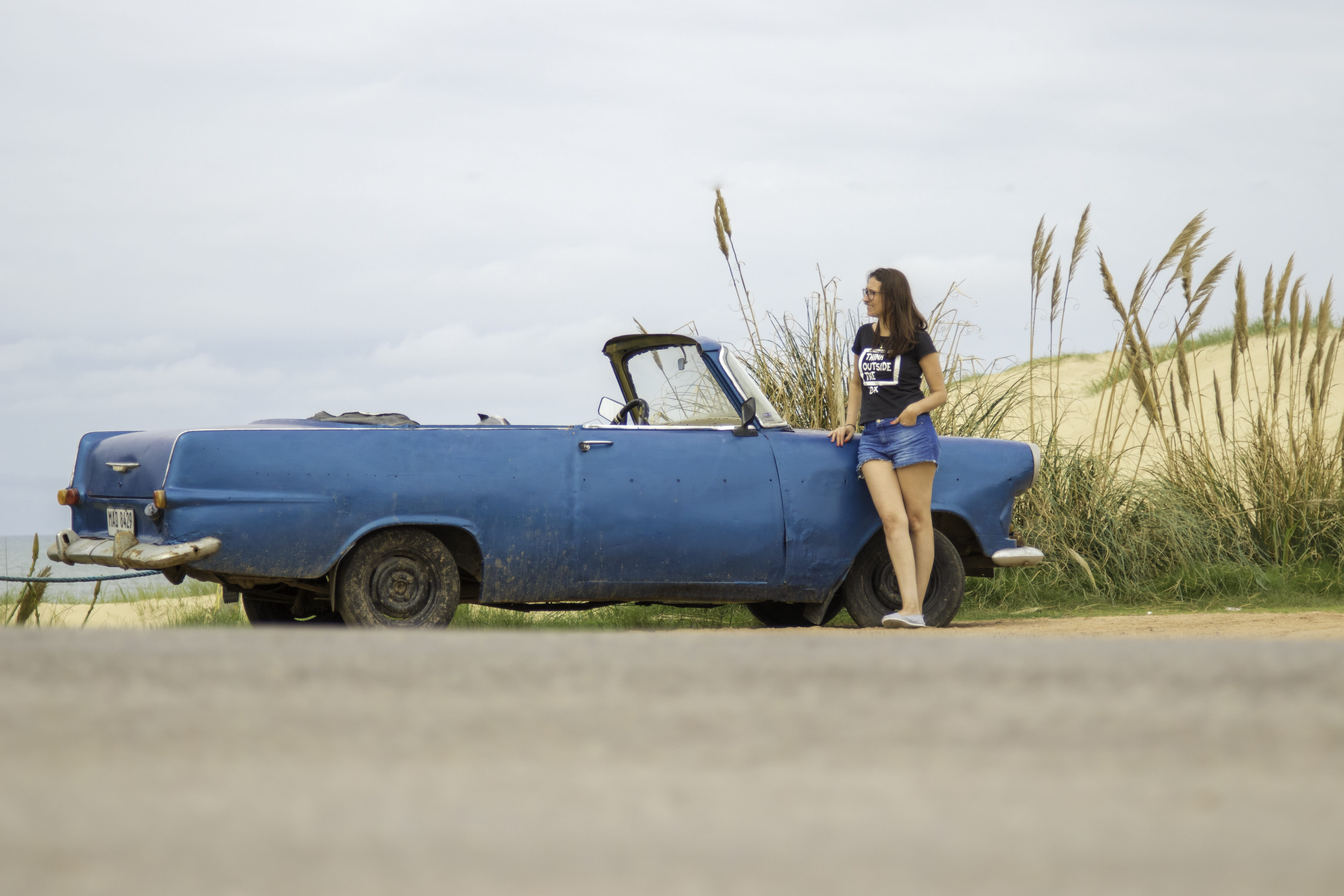 land, vehicle, outdoors, stationary, blue car, people, road, automobile, convertible, punta del diablo, woman, country, blue, shorts, person, coupe, motor vehicle, HD Wallpaper
