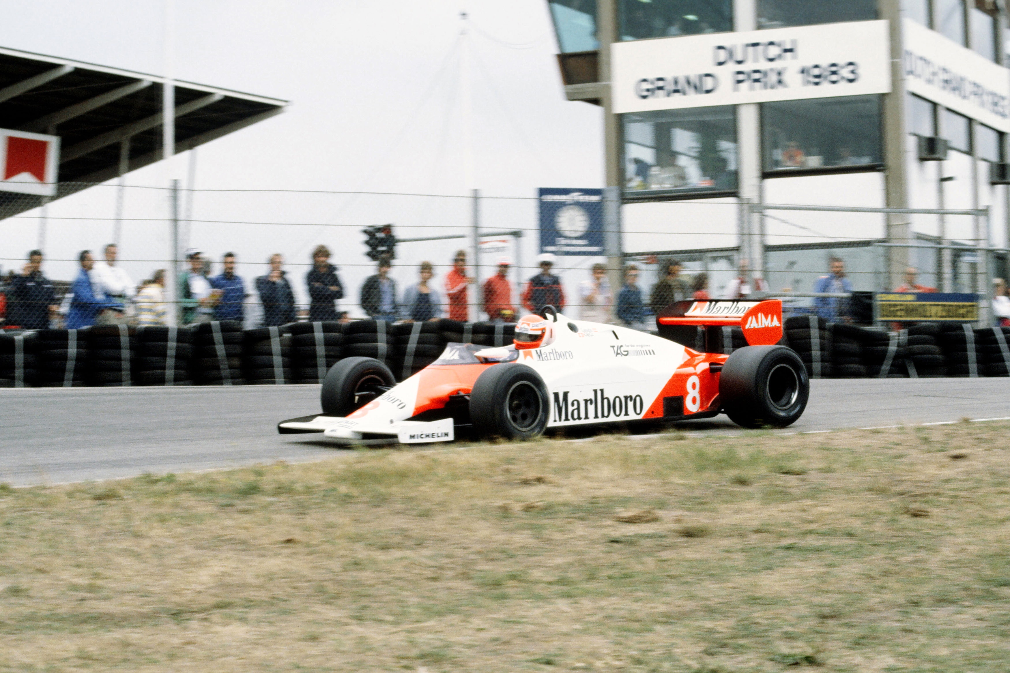text, real people, car, communication, architecture, day, race, city, mp4-1e, building exterior, group of people, racing, formula, 1983, f-1, mclaren, outdoors, HD Wallpaper