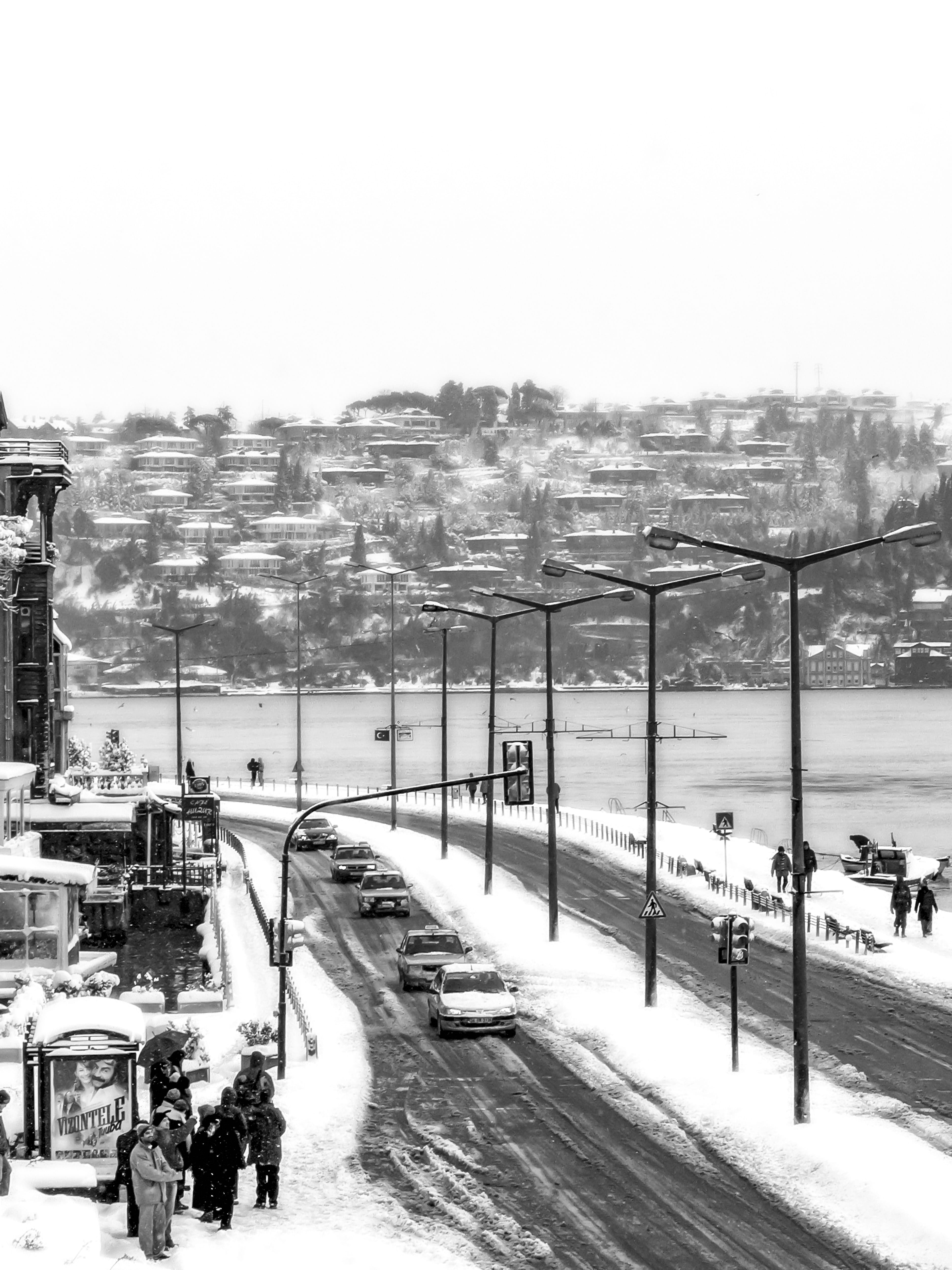 snow, hulki okan tabak, city, cold temperature, snowing, buildings, street lights, sea, people, sky, building exterior, cityscape, road, istanbul, 2005, Phone HD Wallpaper