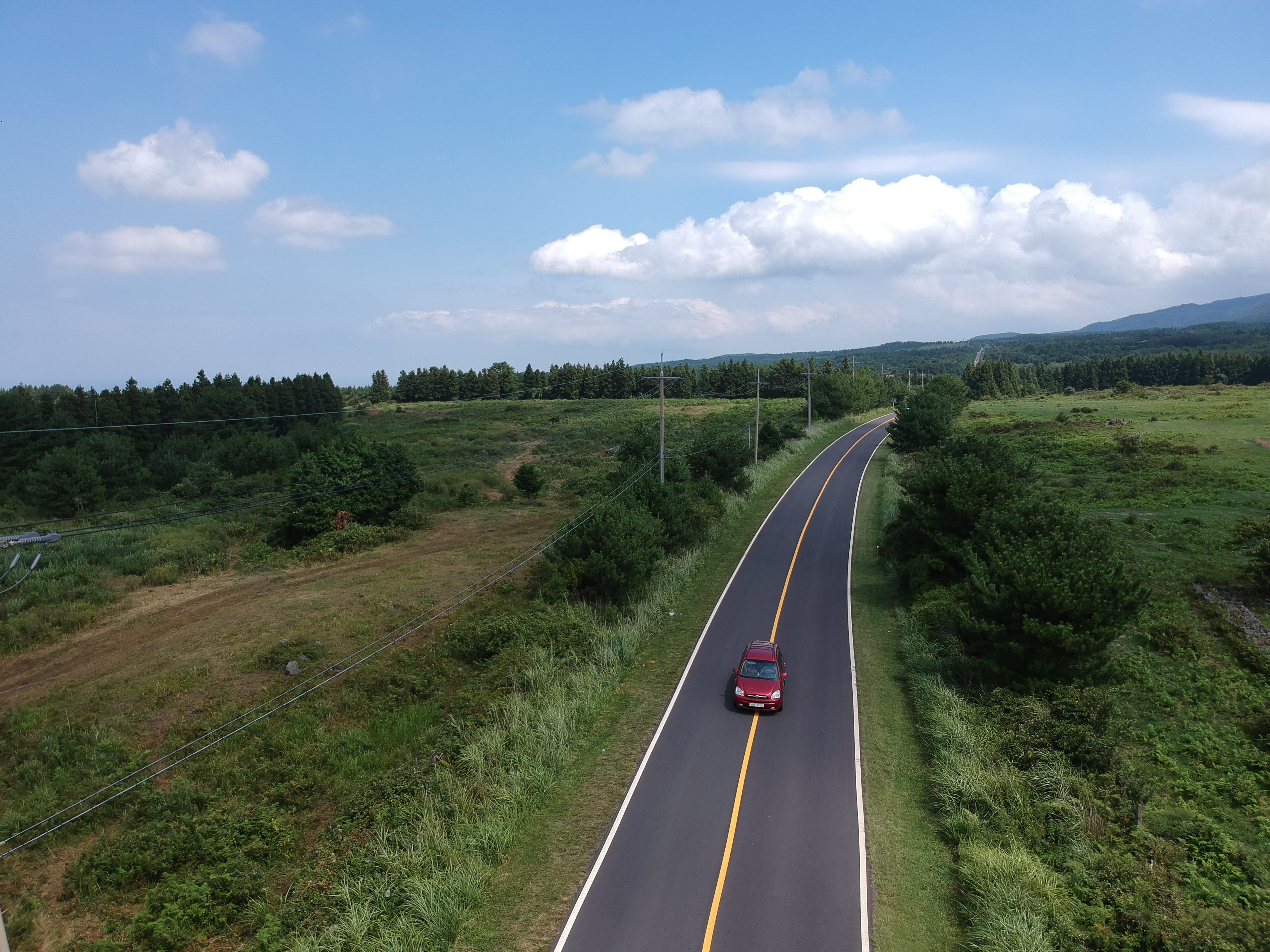 beauty in nature, island, korea, jeju-do, environment, outdoors, sign, car, plant, cloud - sky, motor vehicle, no people, mode of transportation, road, HD Wallpaper