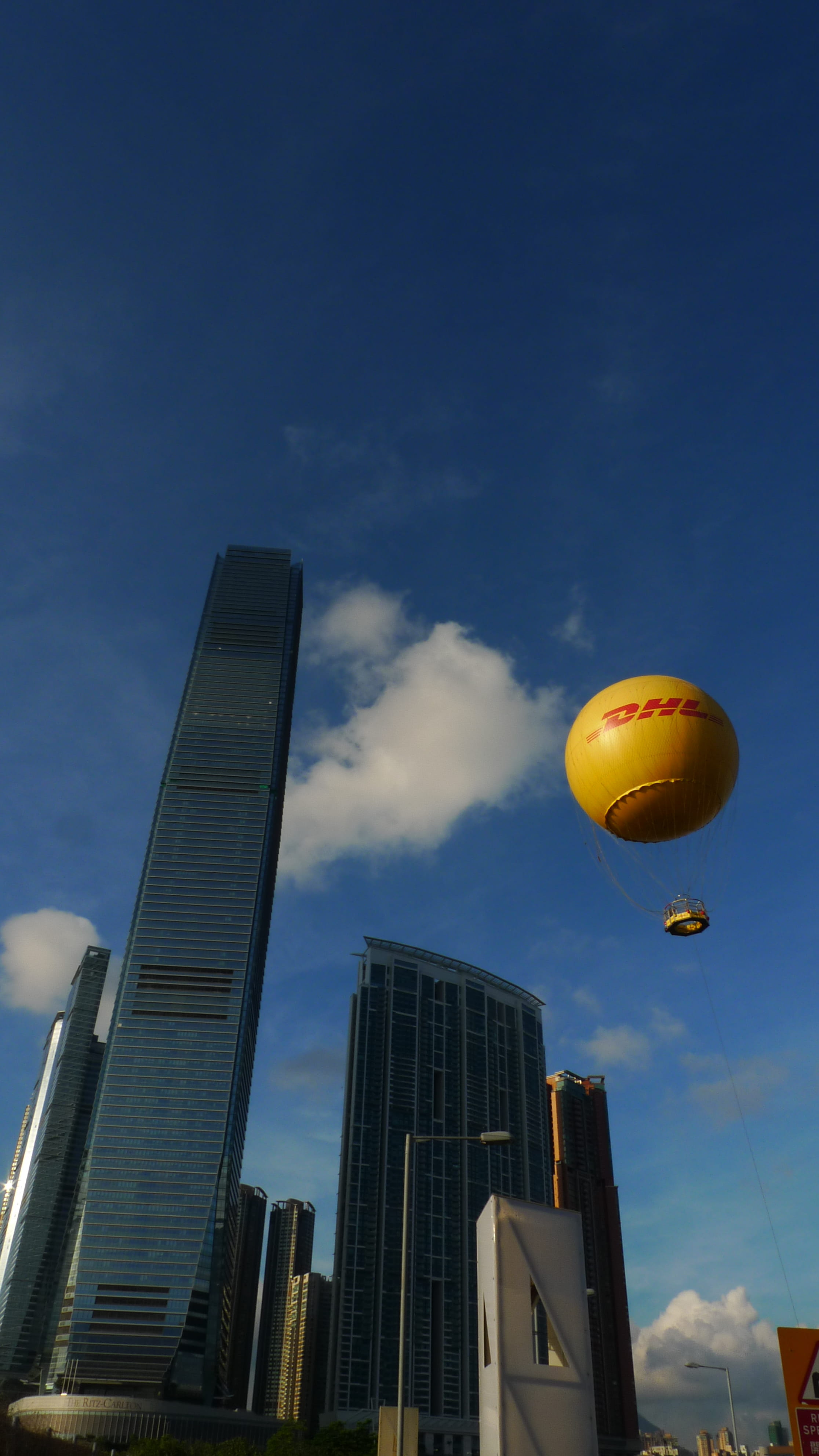 hong kong, low angle view, building, cloud - sky, sky, skyscraper, office building exterior, flying, building exterior, city, balloon, nature, tall - high, Phone HD Wallpaper
