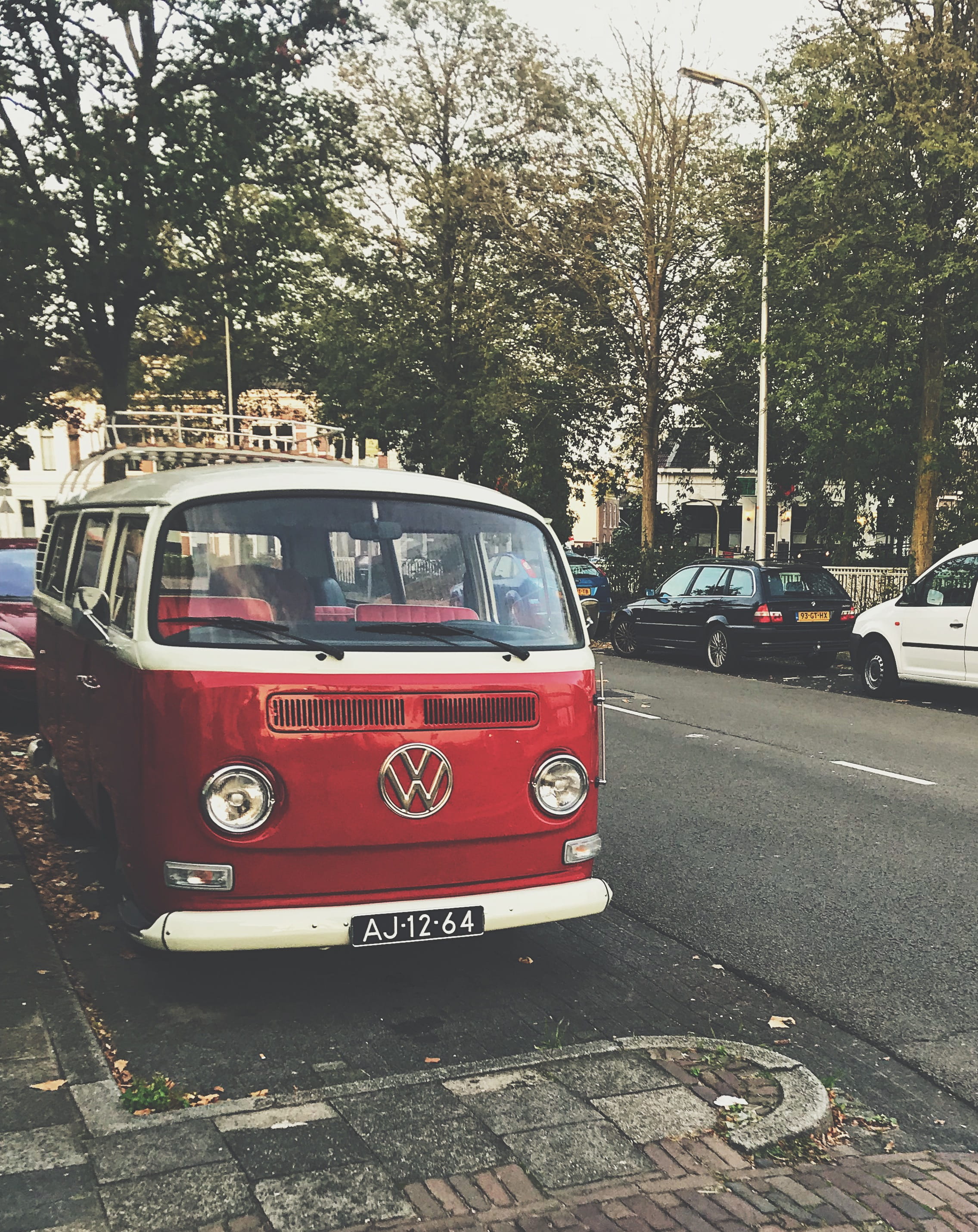 building exterior, architecture, parked, traffic, city, red, 2K, road, nature, street, motor vehicle, combi, automotive, day, volkswagen, transportation, Phone HD Wallpaper