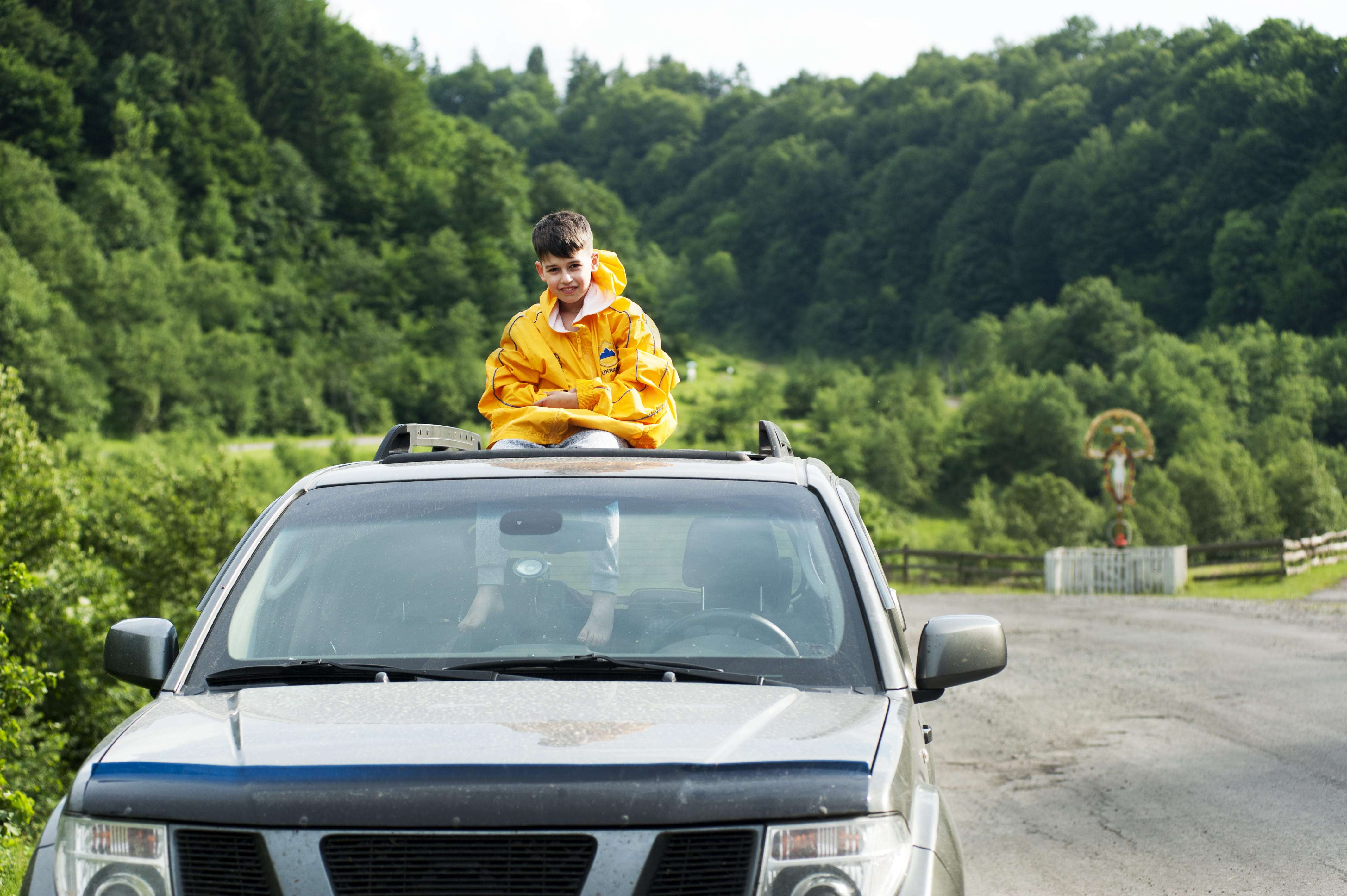 jacket, sunroof, automobile, mode of transportation, little boy, car, child, road, motor vehicle, positive emotion, nature, 4K, females, men, adult, frontier, HD Wallpaper