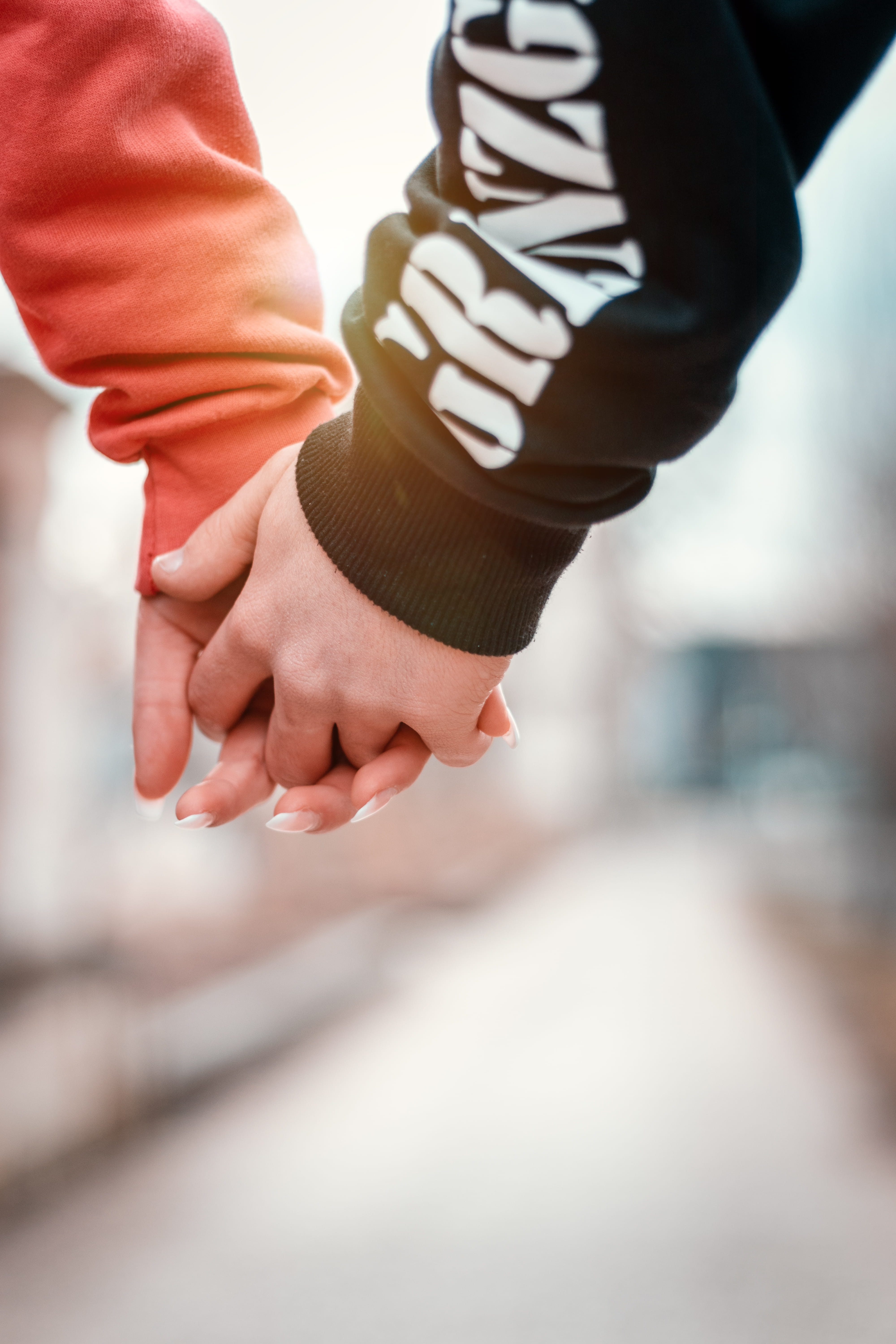 focus on foreground, close-up, arm, holding, person, partner, orange, bonding, hand, people, turquoise, real people, lighten, human limb, body part, emotion, Phone HD Wallpaper