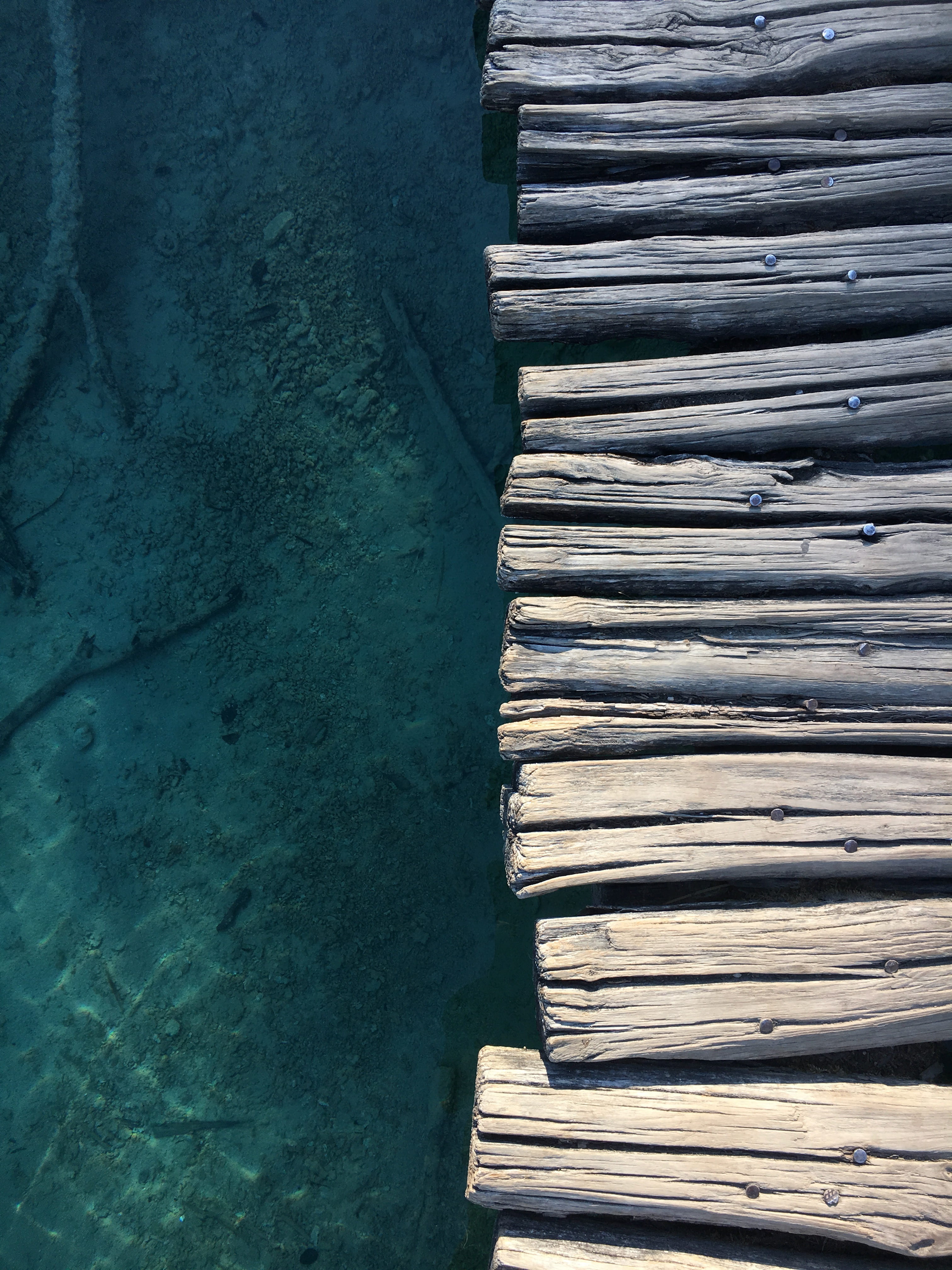 weathered, logs, footbridge, no people, day, in a row, 4K, textured, pattern, close-up, symmetrical, water, high angle view, boardwalk, turquoise, wall - building feature, Phone HD Wallpaper