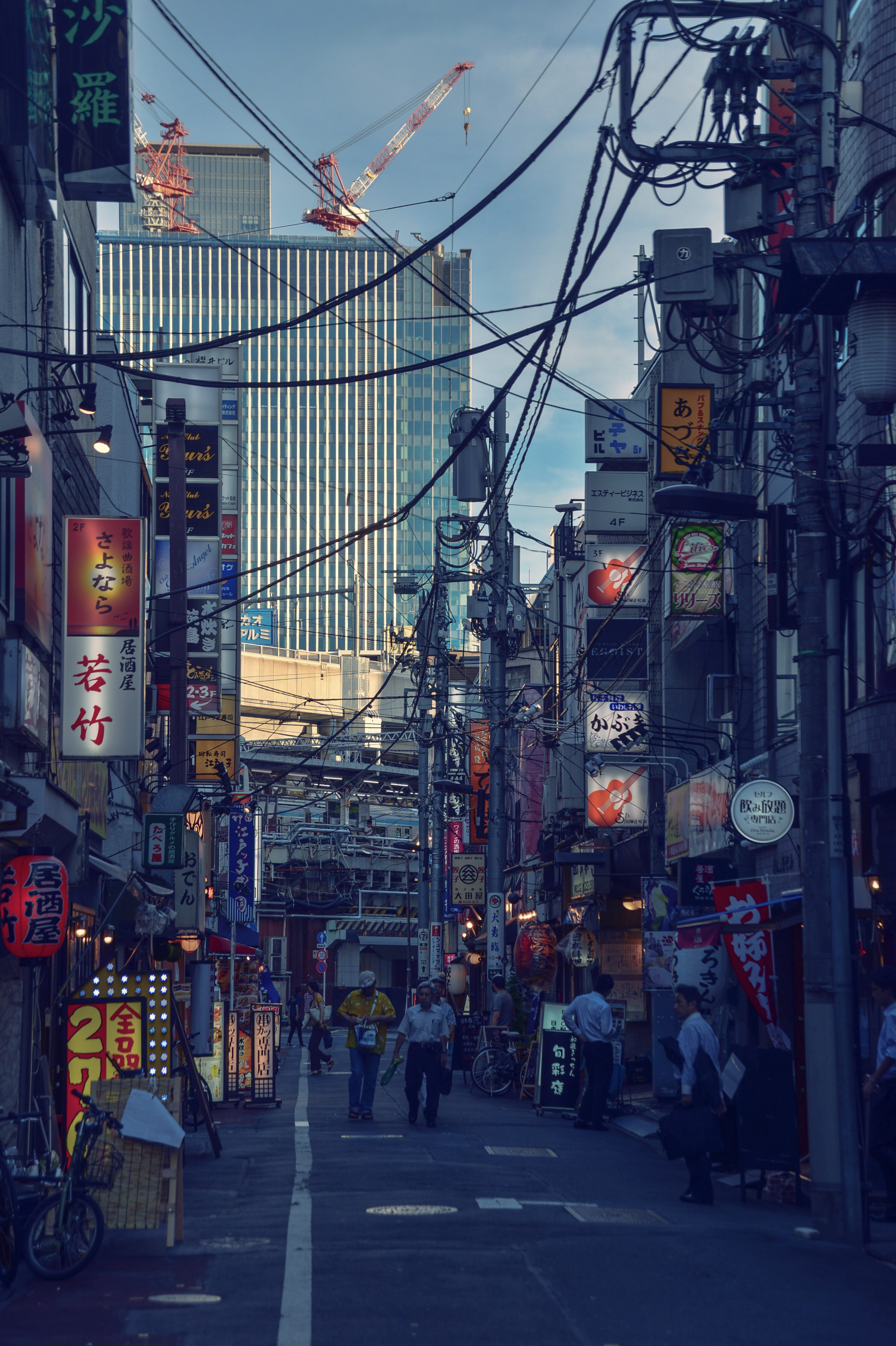 skyscraper, outdoors, shop, city life, crossing, store, city, crane, group of people, drink, men, walking, post, electricity, urban, alleyway, person, built structure, Phone HD Wallpaper