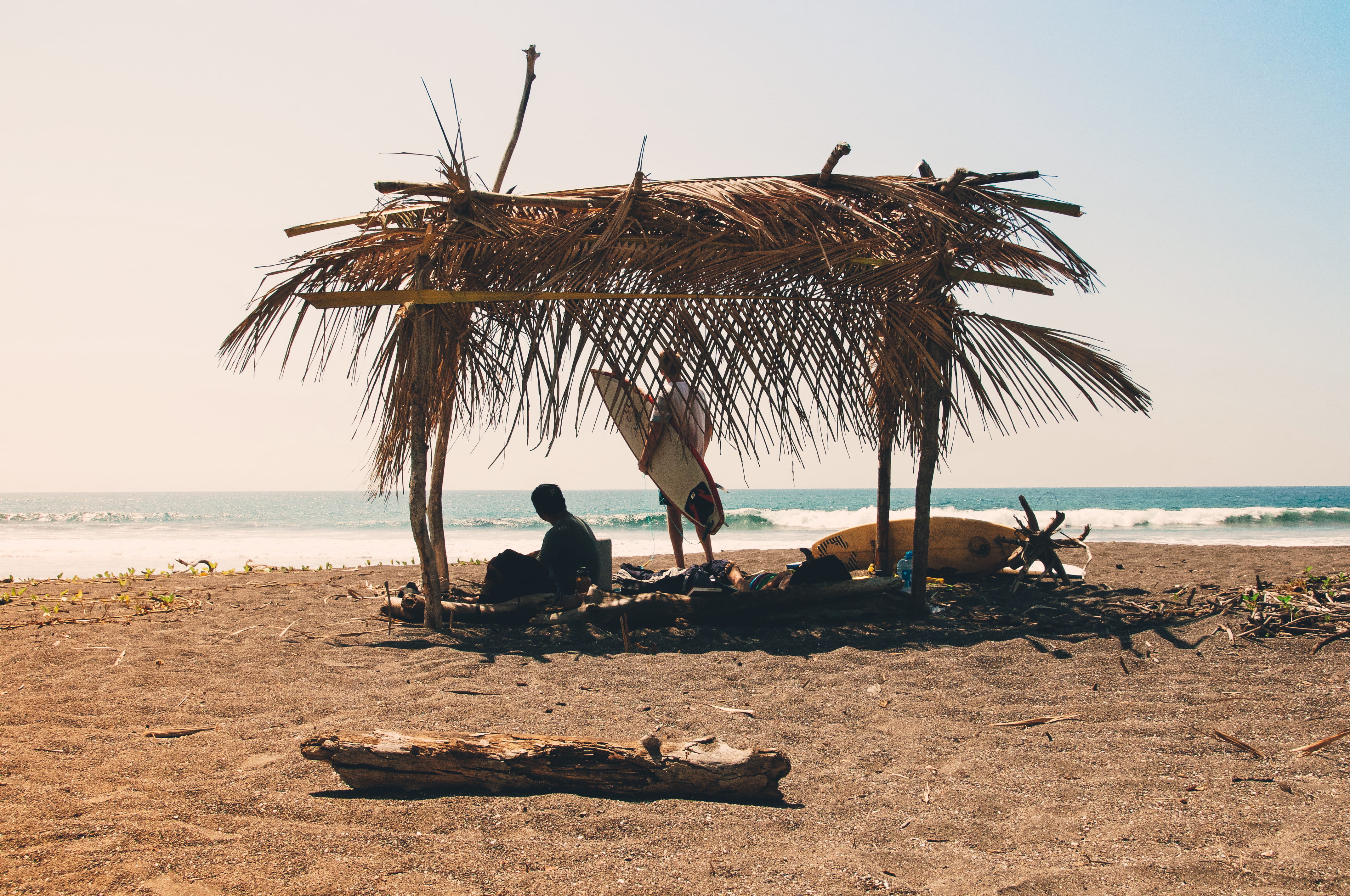 water, near, brown, 4K, shack, vacation, outdoors, surfboard, hut, wafe, thatched roof, sitting, tranquil scene, people, holiday, clear sky, explore, reclining, HD Wallpaper