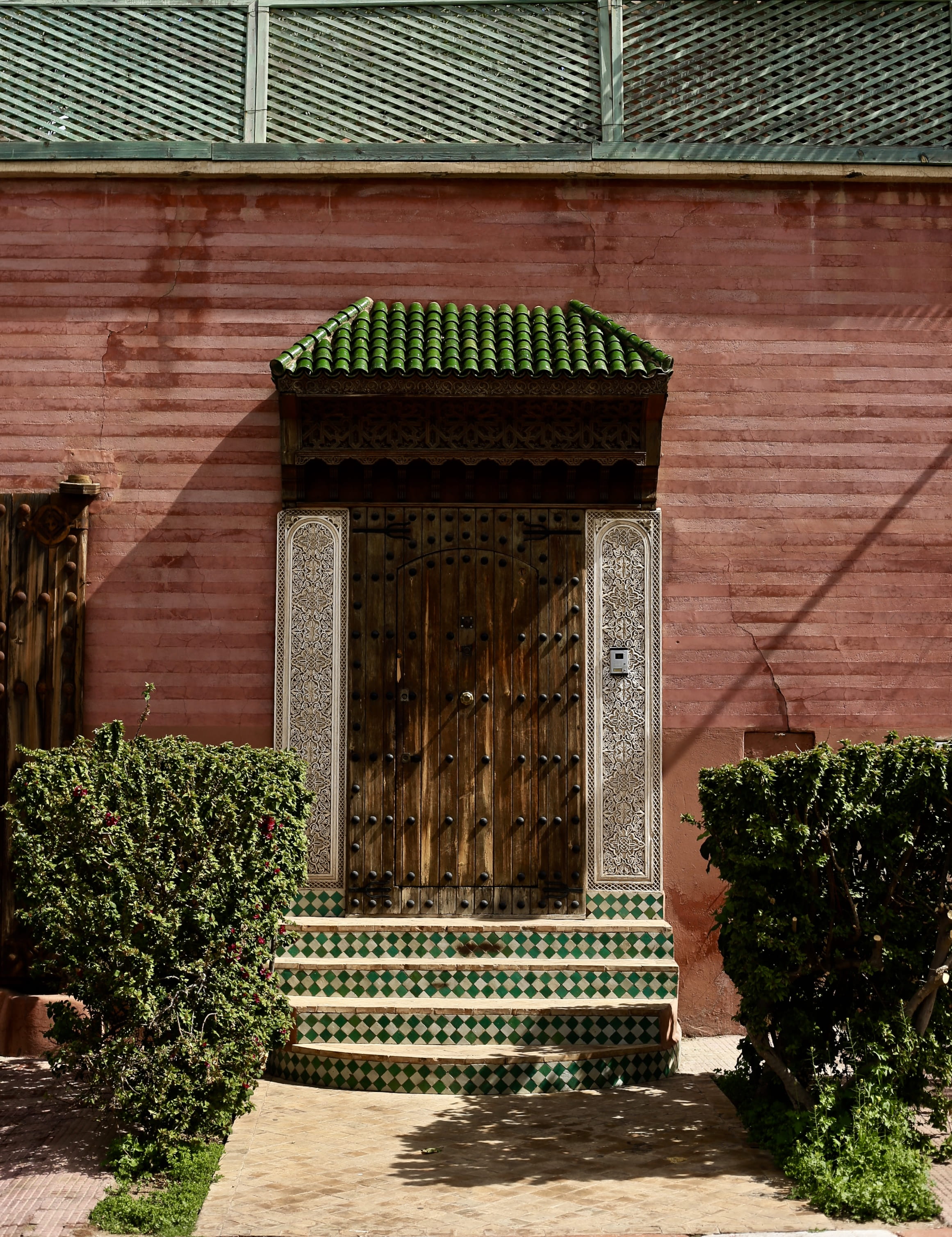 residential district, shadow, 2K, path, near, built structure, concrete, brick wall, lavish, day, nature, hedge, marrakesh, ornate, door, pink, wooden door, Phone HD Wallpaper
