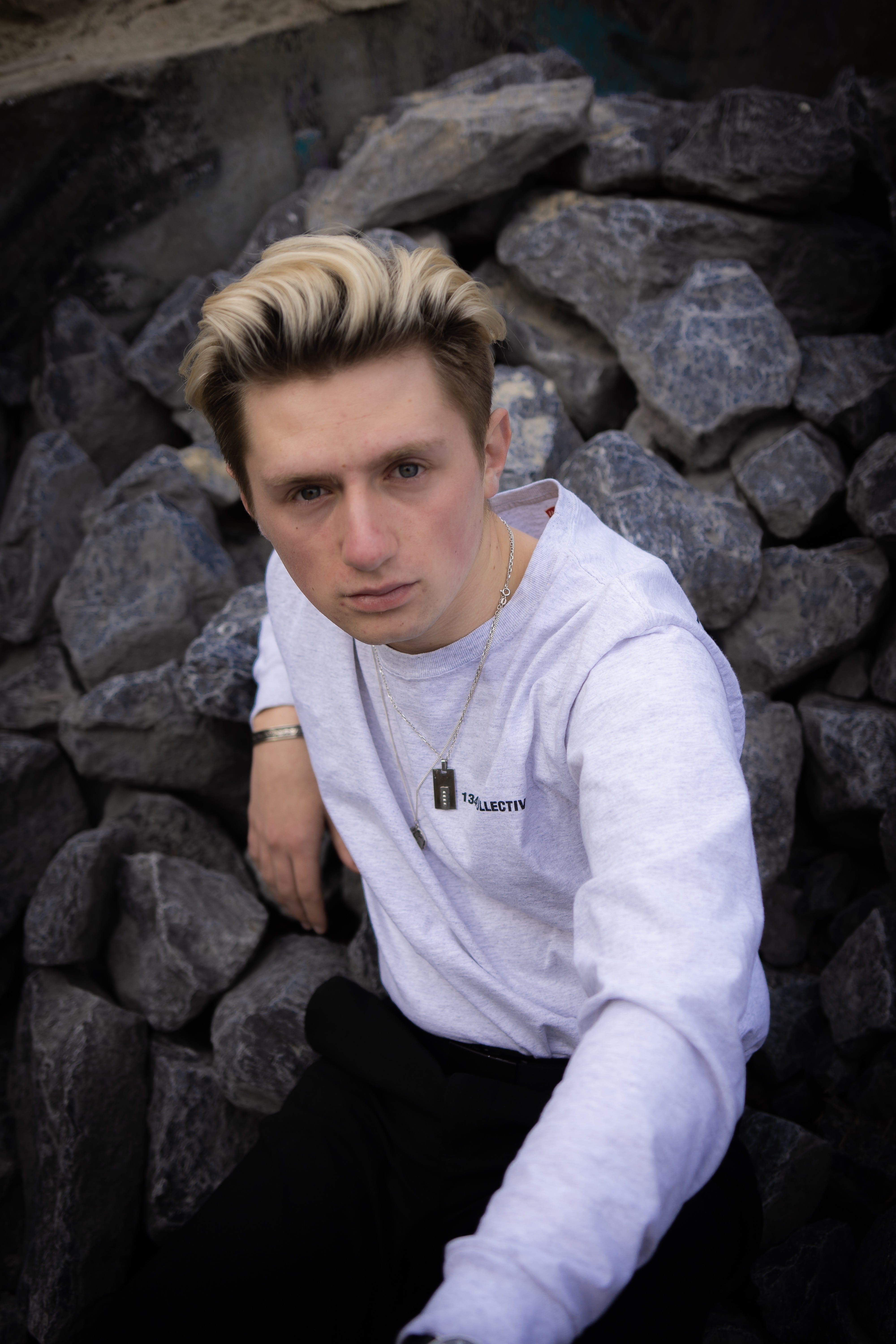 young men, sleeve, 5K, lifestyles, cobblestone, hearth, sidewalk, outdoors, casual clothing, rubble, wall, solid, looking at camera, stone wall, walkway, Phone HD Wallpaper
