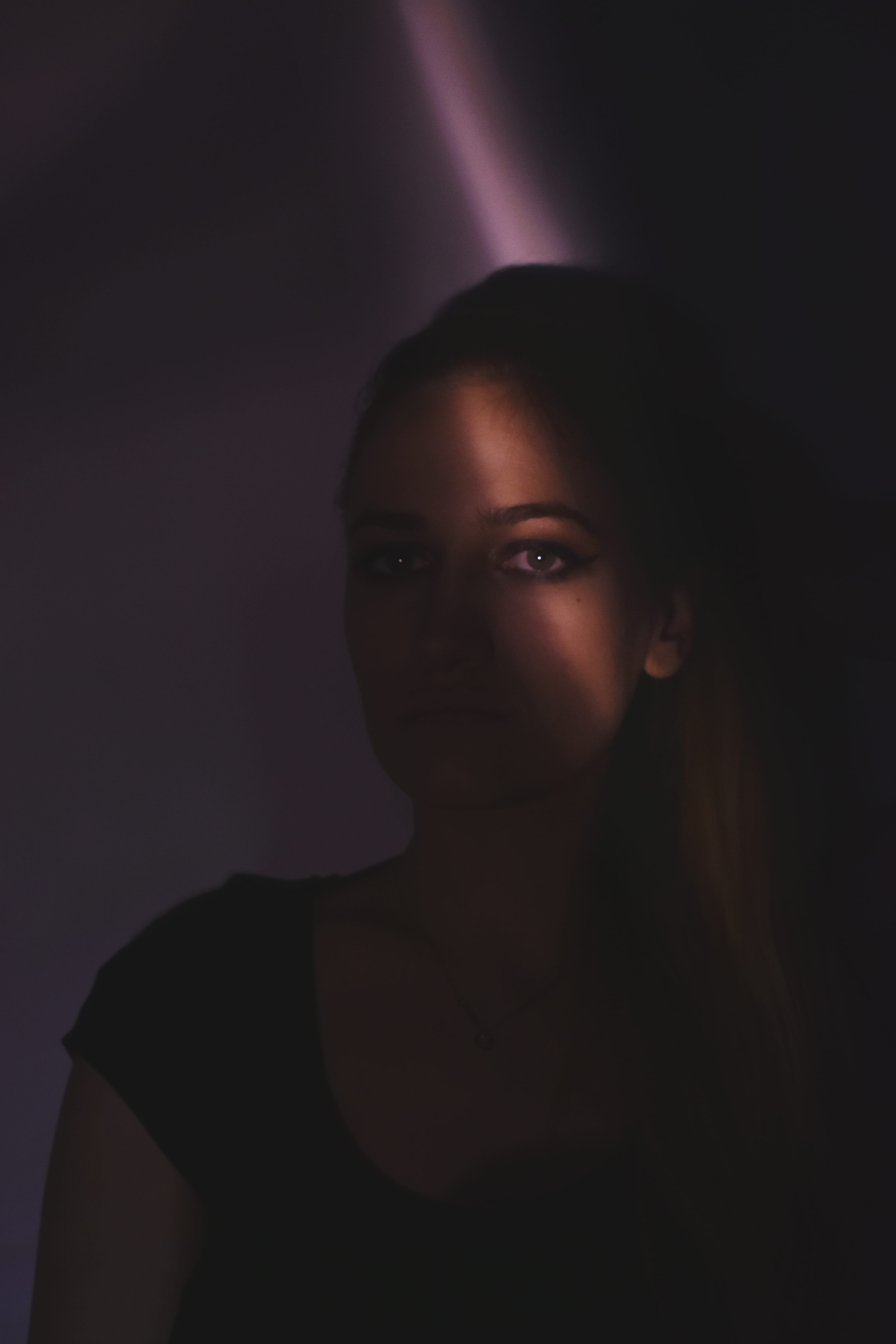 shirt, front view, young adult, lifestyles, fashion, beautiful woman, serious, person, art, inside, 5K, black background, women, portrait, light, face, Phone HD Wallpaper