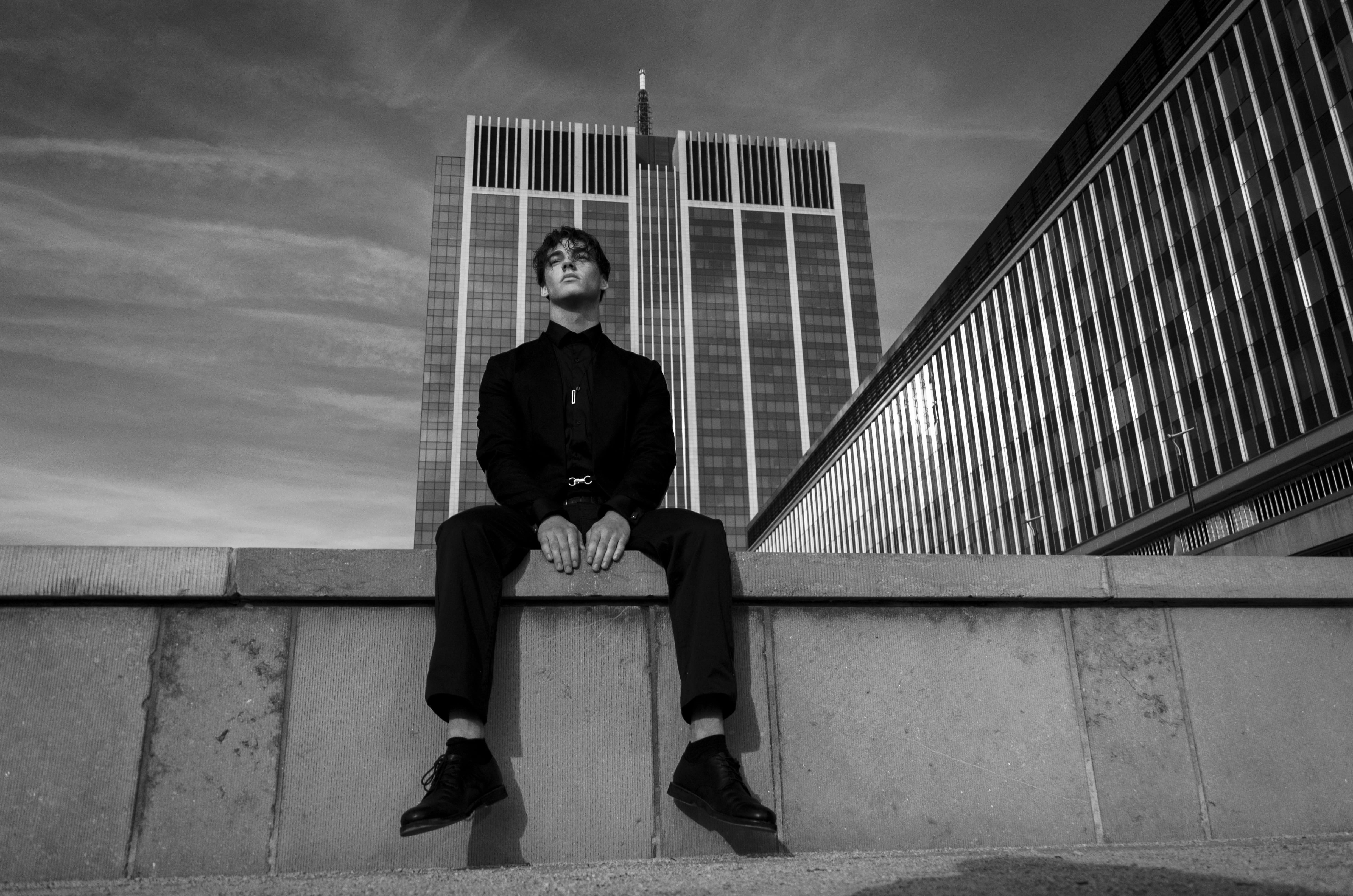 grayscale, unsplash, sitting, wall, looking at camera, architecture, night, male, young women, casual clothing, full length, 4K, built structure, real people, HD Wallpaper