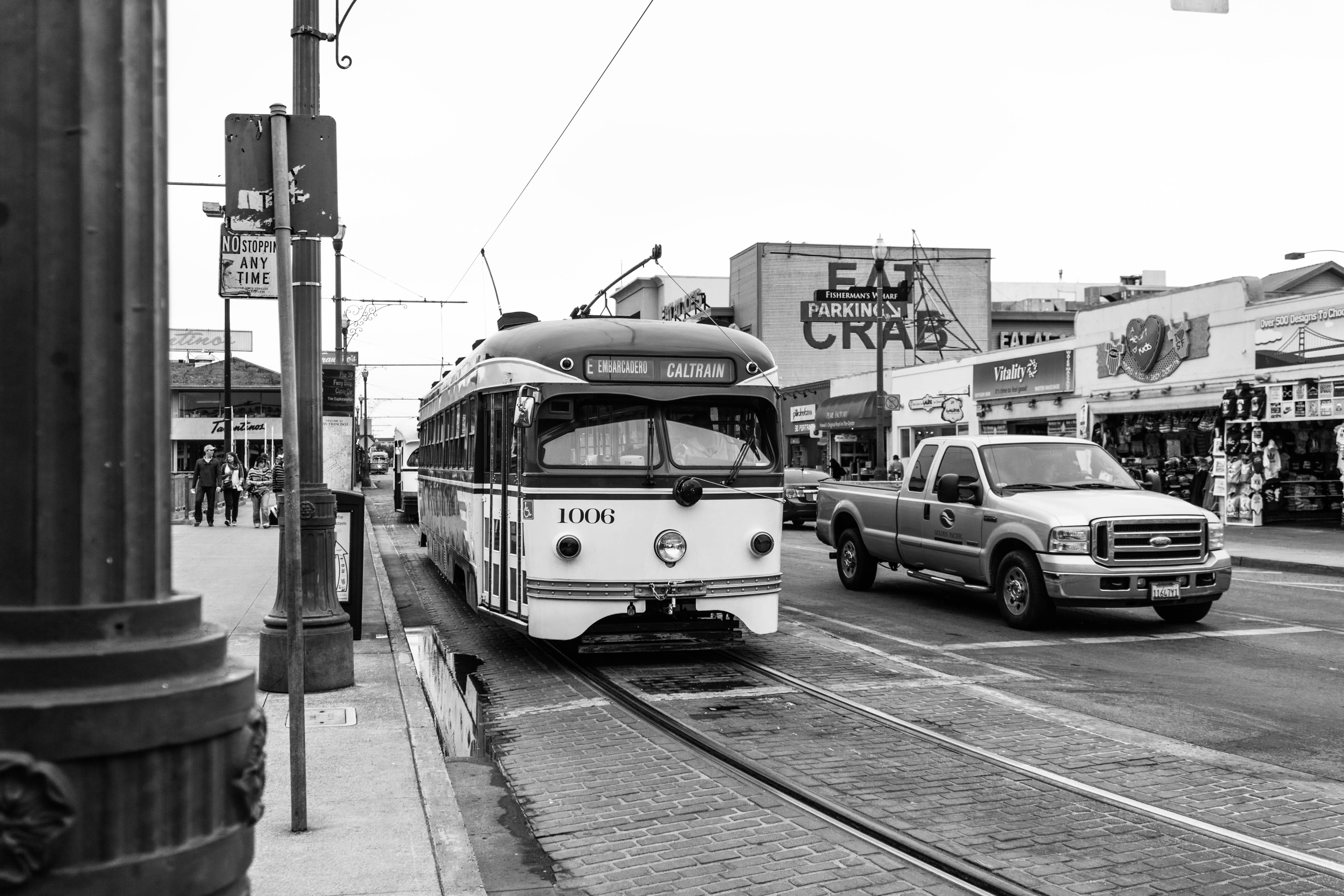 cable car, automobile, building exterior, greyscale, city, motor vehicle, wheel, land vehicle, bus, person, rail transportation, railroad track, road, public transportation, HD Wallpaper
