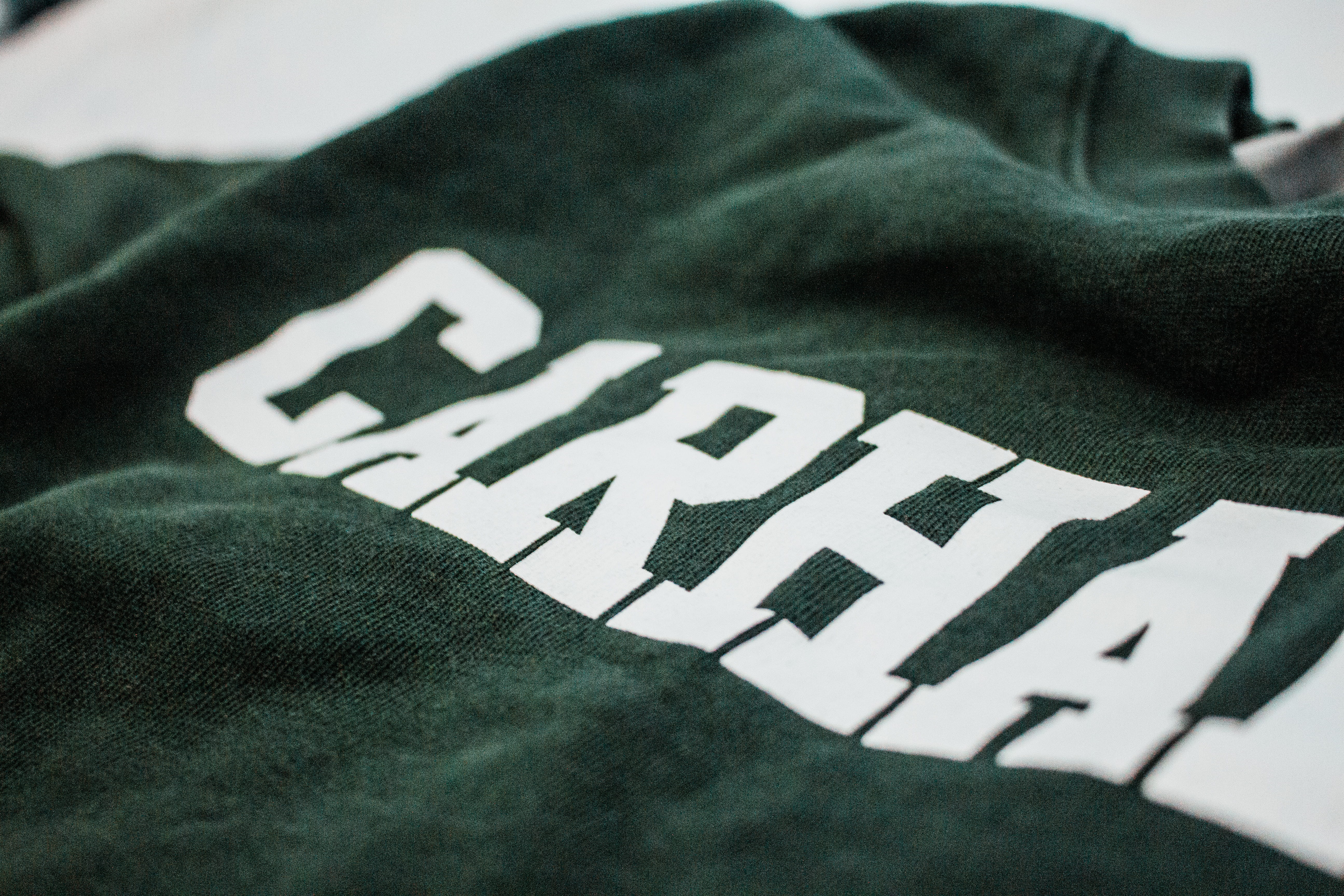 handwriting, t-shirt, human hand, 5K, apparel, body part, one person, carhartt, real people, sleeve, green, crewneck, textile, leisure activity, furniture, HD Wallpaper