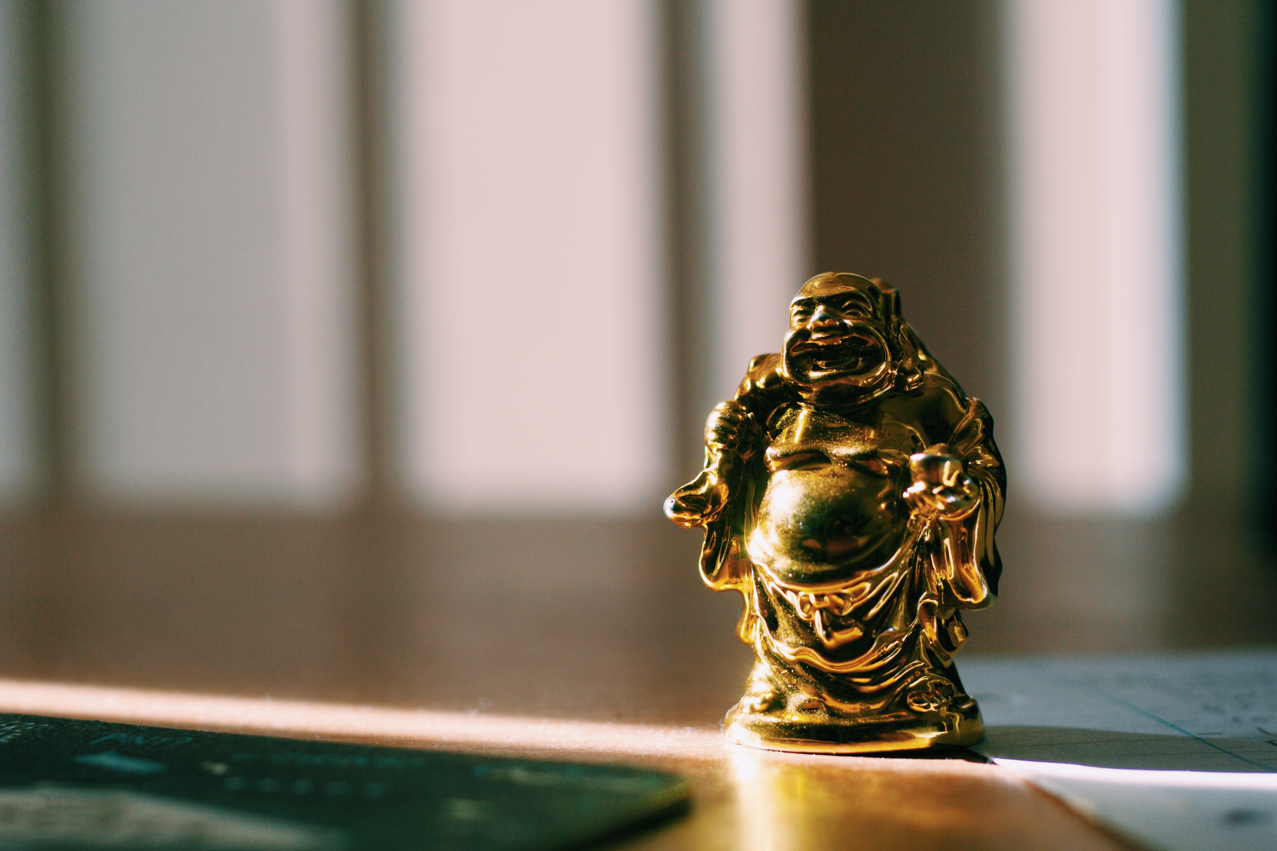 selective focus, focus on foreground, small, metal, statue, creativity, close-up, desk, table, gold, no people, spirituality, buddha, single object, art and craft, HD Wallpaper