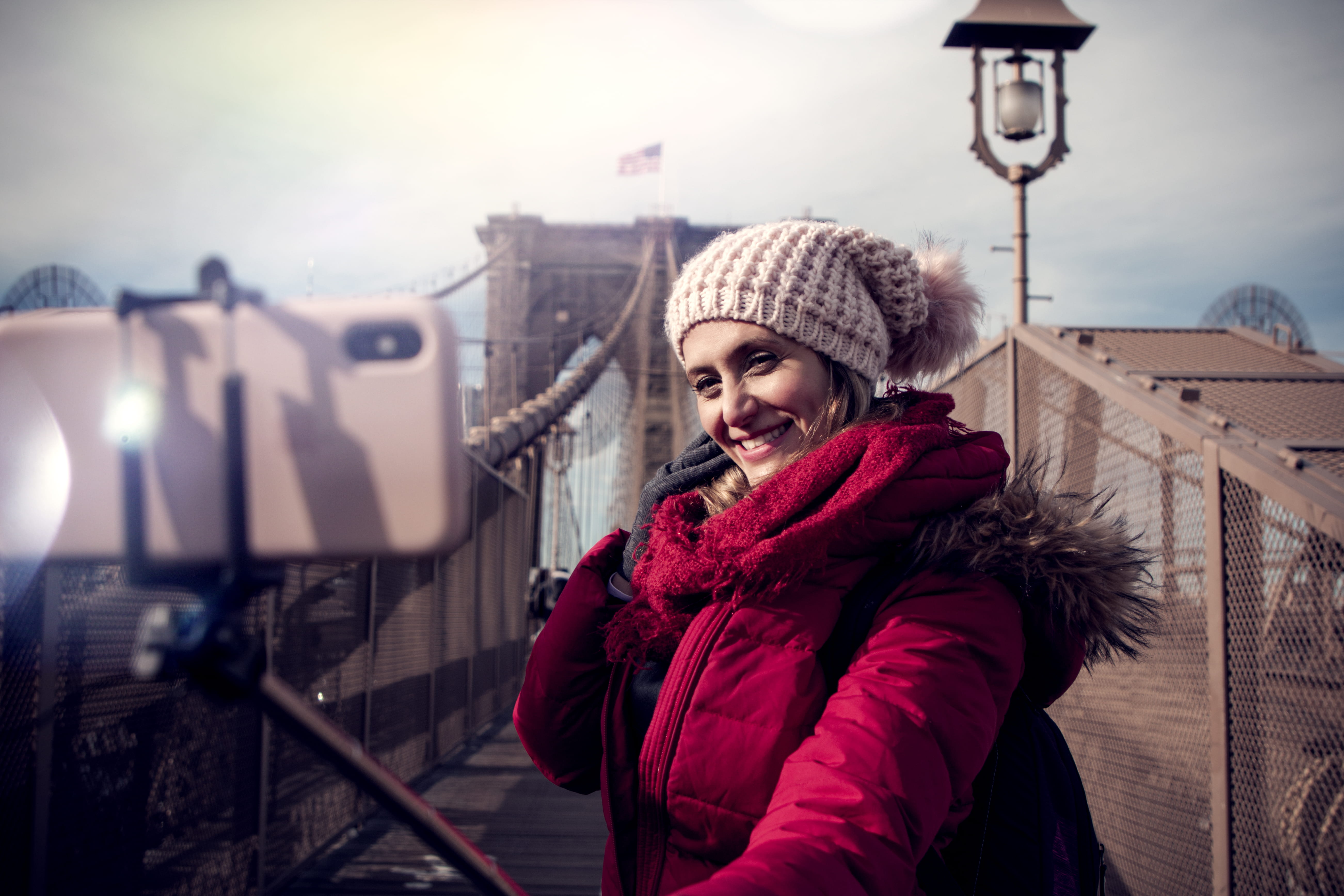 smiling, zip, phone, emotion, lifestyles, person, urban, architecture, winter, beanie, taking photo, jacket, knit hat, brookline bridge, cold temperature, HD Wallpaper