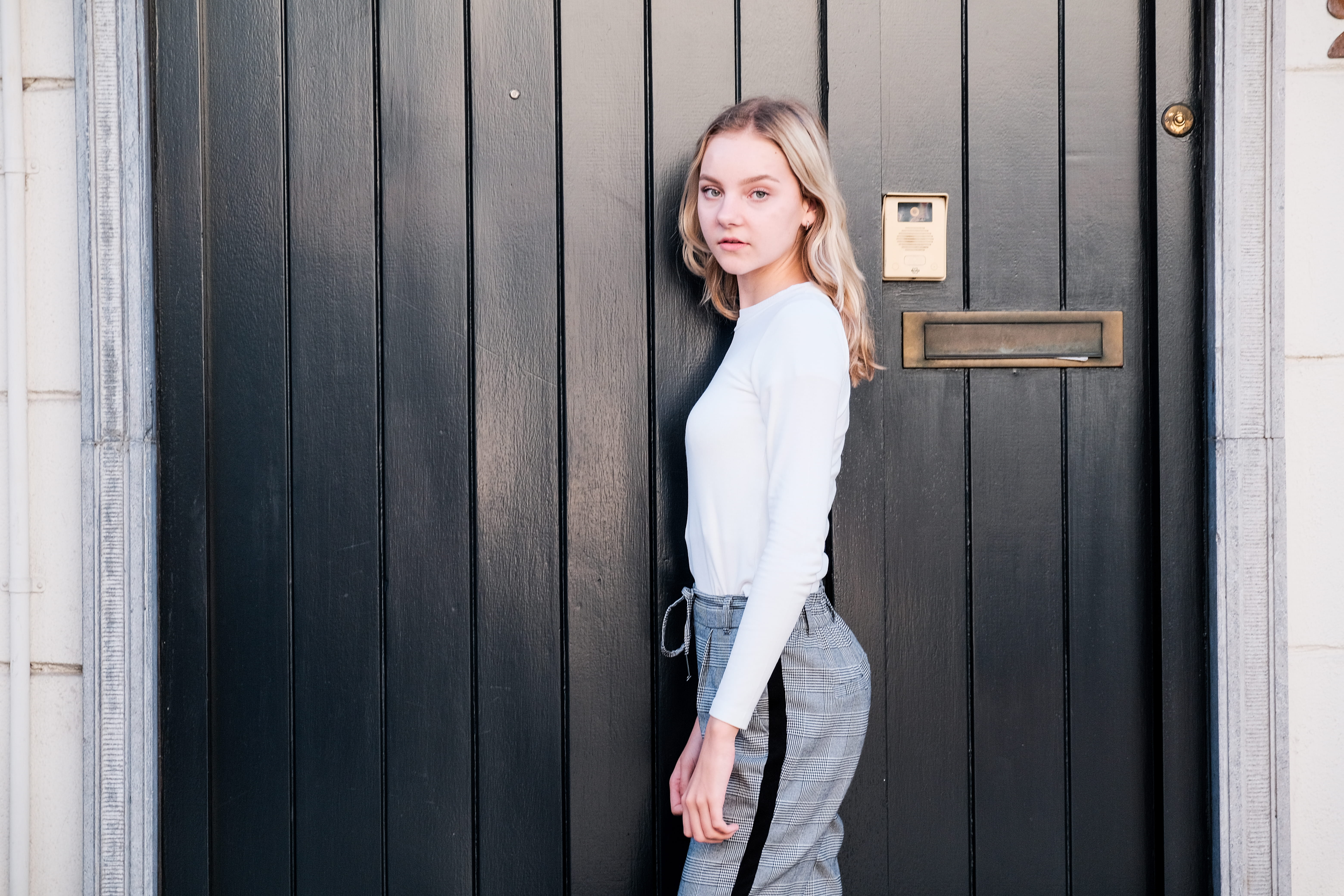 adult, door, lady, three quarter length, black, outdoors, person, girl, day, wall, front view, young, beside, casual clothing, young women, looking at camera, HD Wallpaper