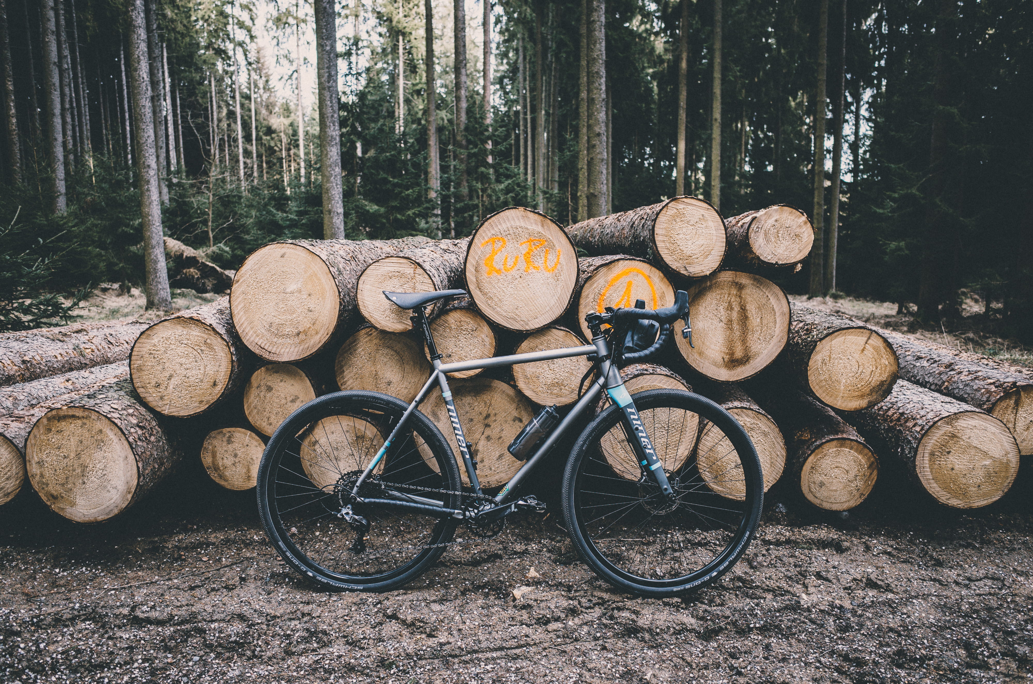 black, ride, trunk, plant, cx, outdoor, stack, wood - material, day, cycle, woodland, pile, fitness, land, gray, mud, road, large group of objects, bike, HD Wallpaper
