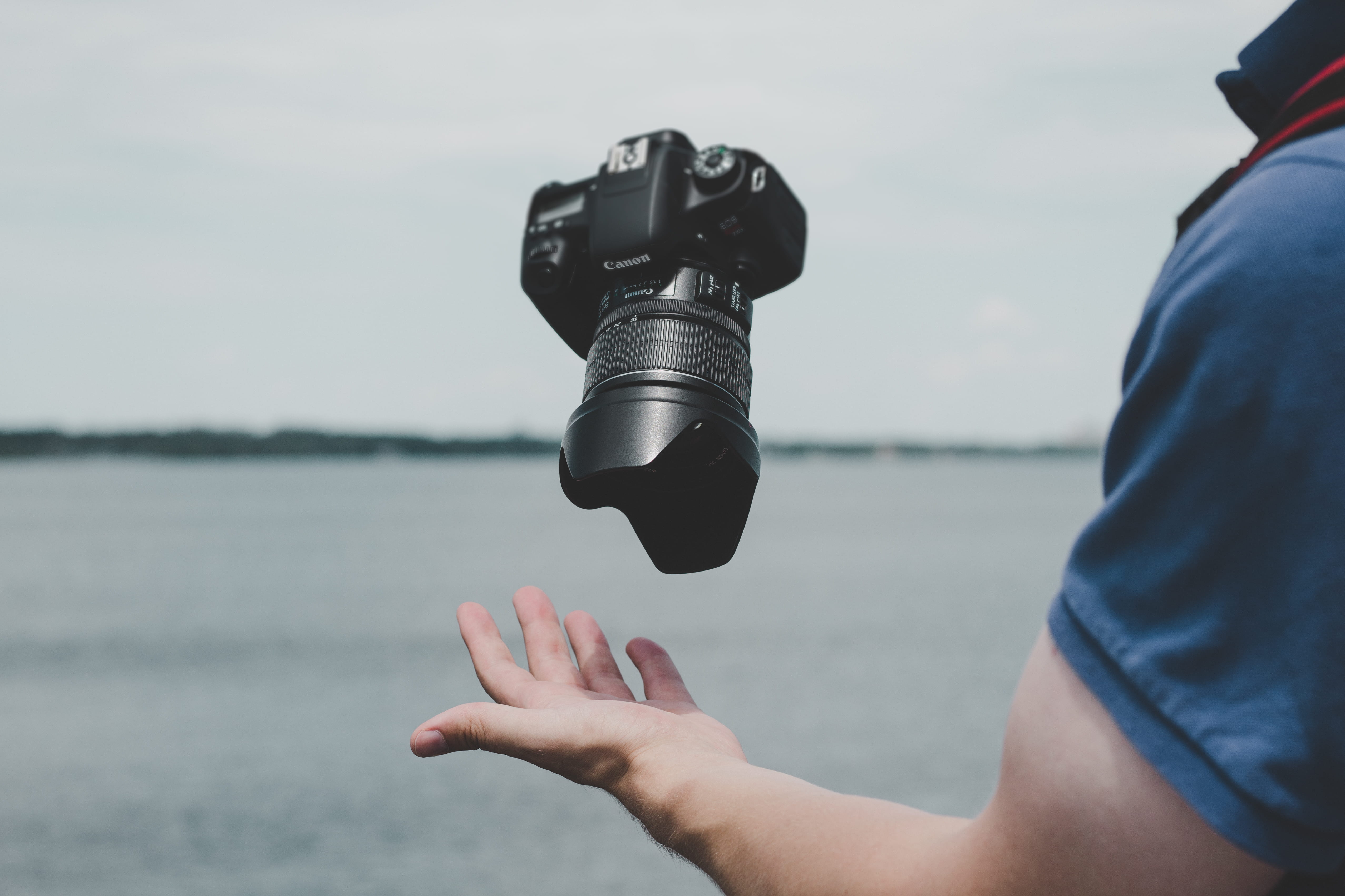 finger, sea, shirt, holding, caucasian Ethnicity, leisure activity, human hand, digital camera, water, adult, real people, person, photographic equipment, HD Wallpaper